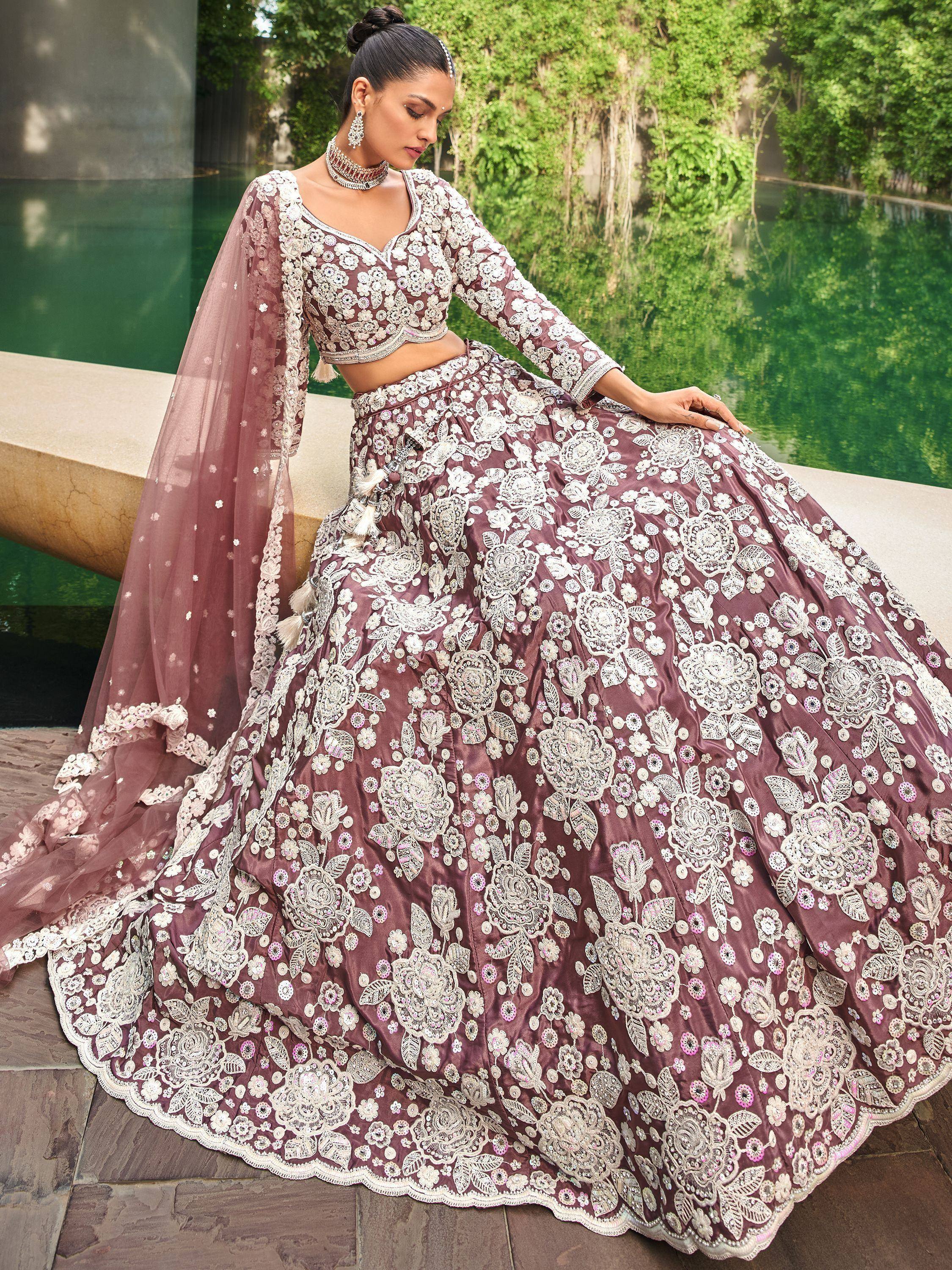 Elegant mauve lehenga choli with intricate white floral embroidery, perfect for Indian weddings and festive occasions.