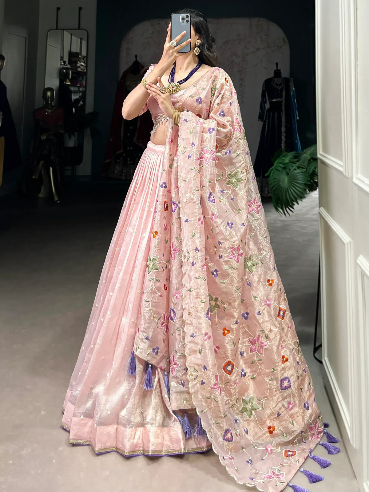 Pink floral embroidered lehenga choli with purple tassels, perfect for Indian ethnic wear occasions