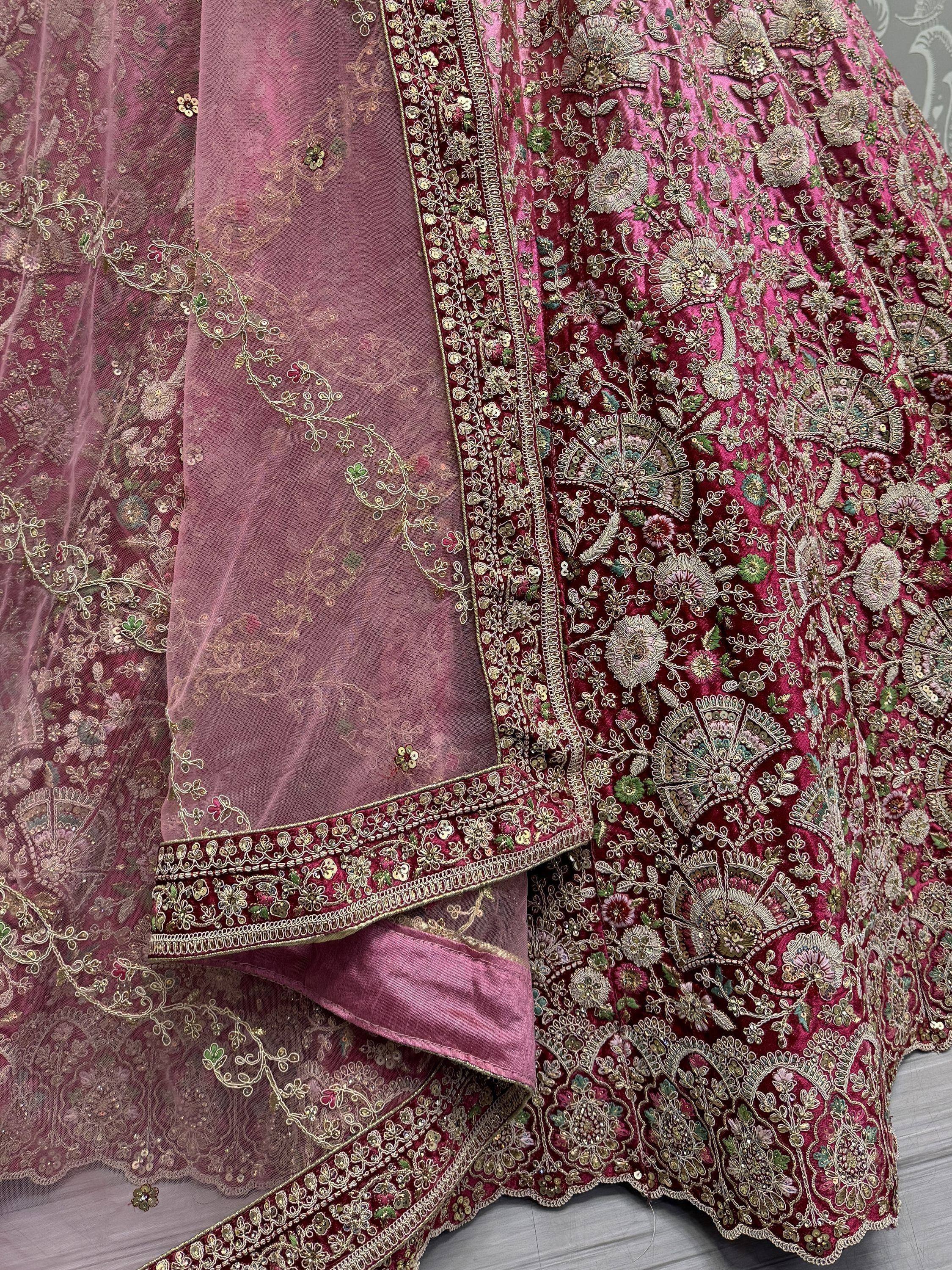 Luxury pink velvet lehenga choli with intricate gold floral embroidery and matching dupatta, perfect for Indian weddings.