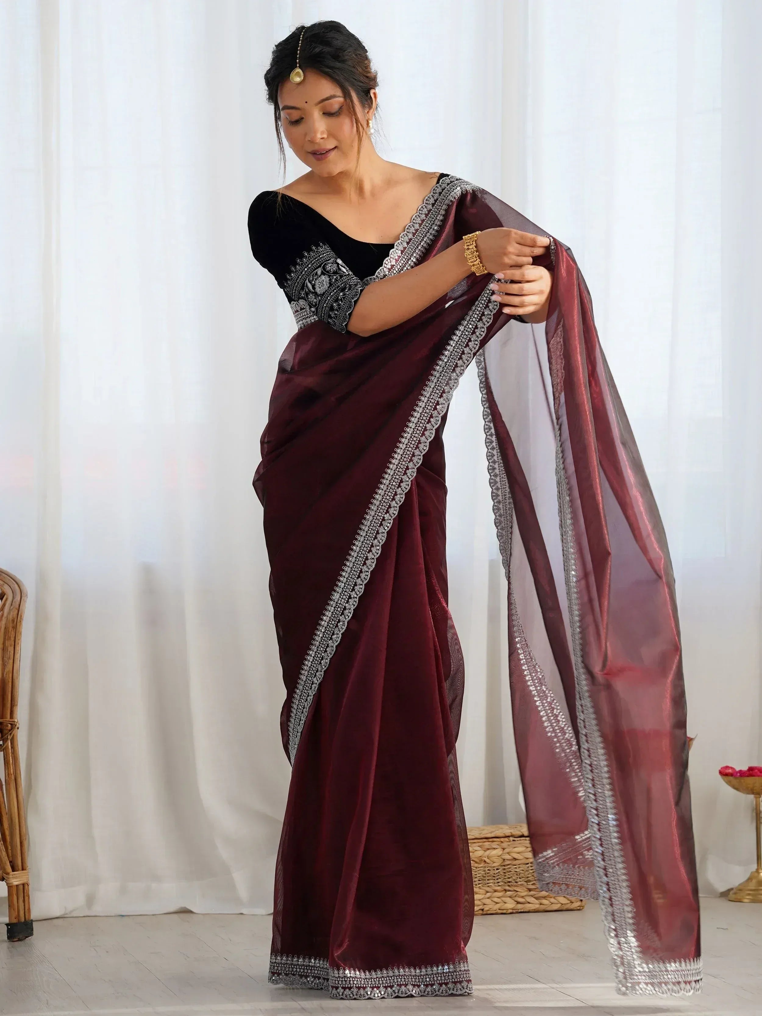 Burgundy velvet saree with silver embroidery, paired with black blouse, perfect for Indian ethnic wear occasions.