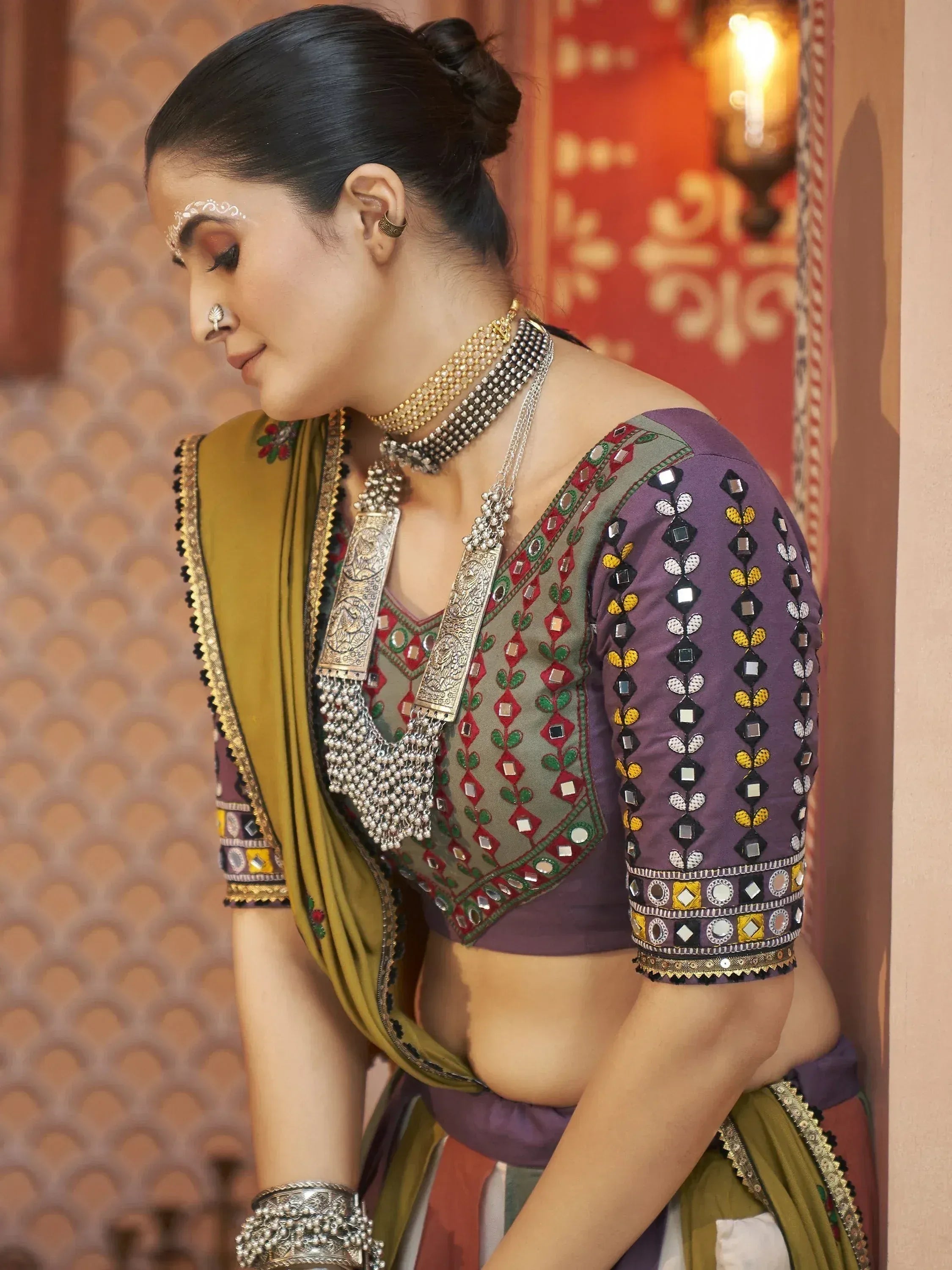Woman in purple mirror-work blouse with green dupatta, traditional Indian ethnic wear, designer lehenga choli