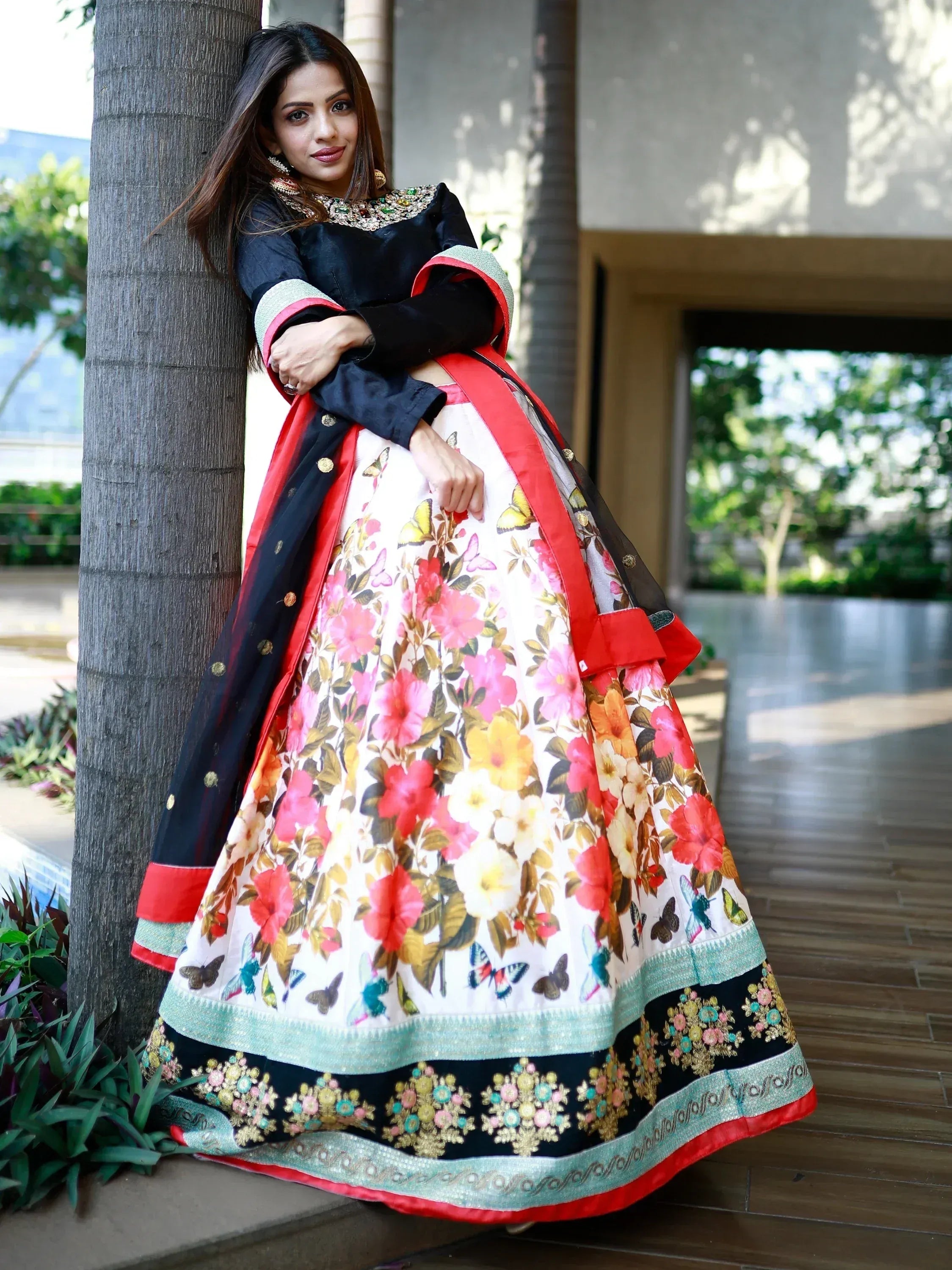 Woman in floral butterfly print lehenga choli with black blouse, perfect for Indian ethnic wear occasions