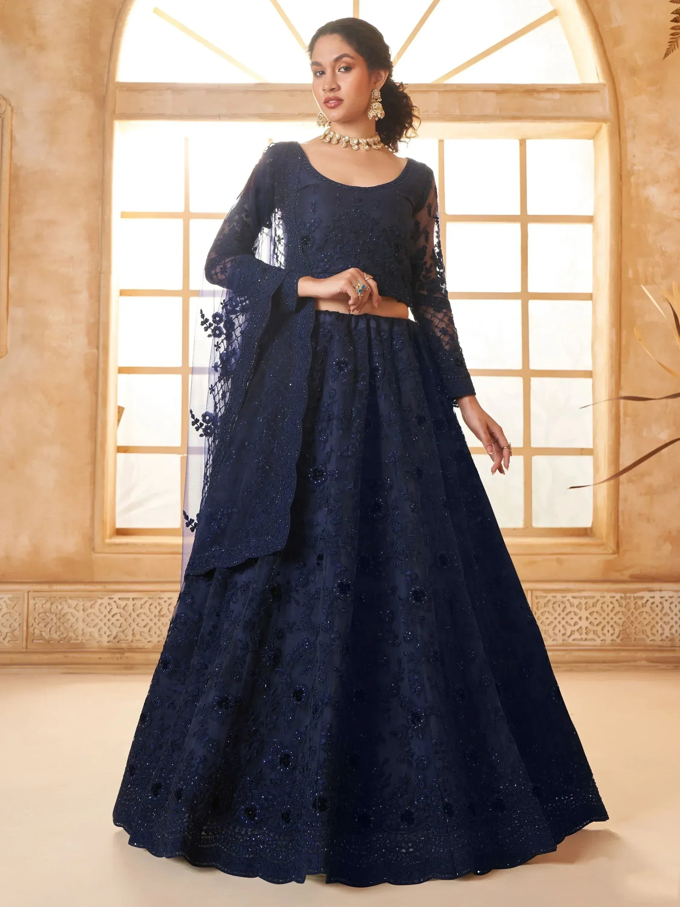 Navy blue embroidered lehenga choli with sheer dupatta, perfect for Indian weddings and festive occasions.