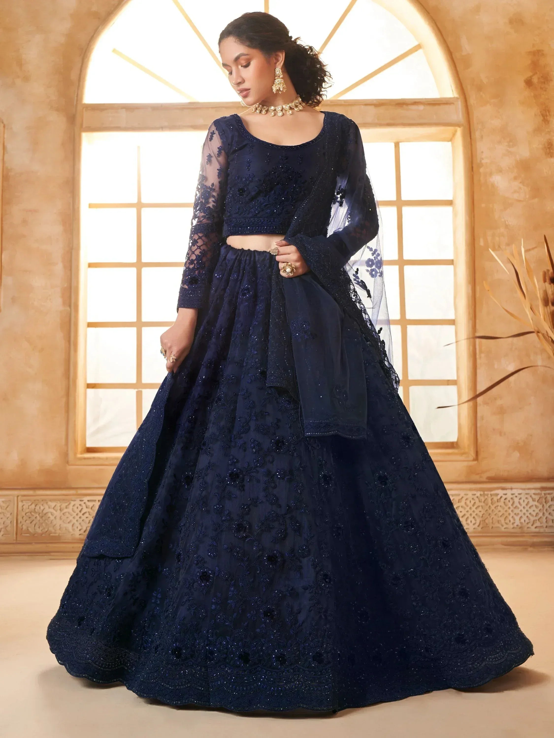 Navy blue embroidered lehenga choli with sheer sleeves and dupatta, perfect for Indian ethnic wear events.