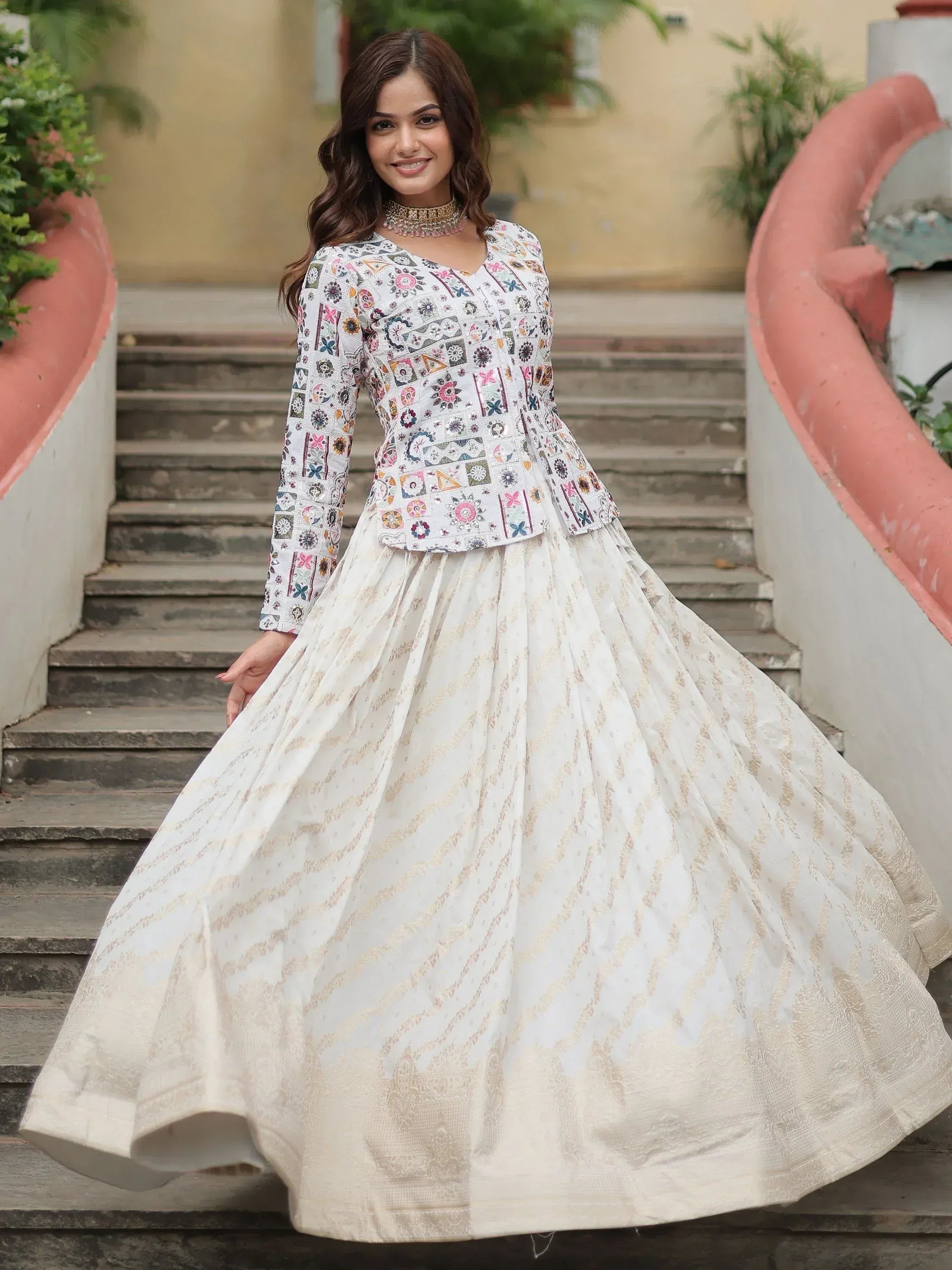 White embroidered lehenga choli with floral top and gold patterned skirt, ideal for Indian ethnic wear occasions