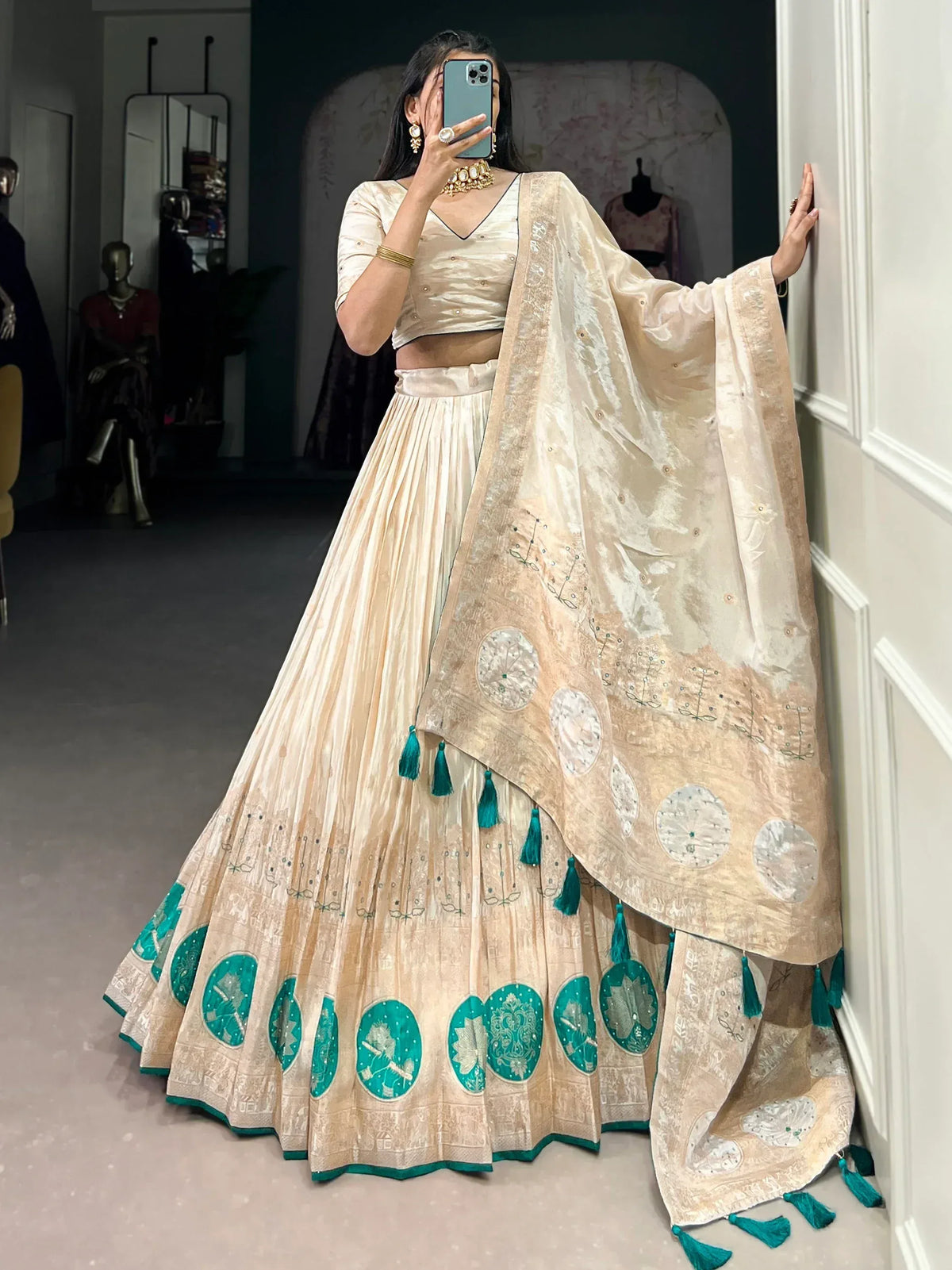 Cream and teal embroidered lehenga choli with tassels, perfect for Indian ethnic wear occasions