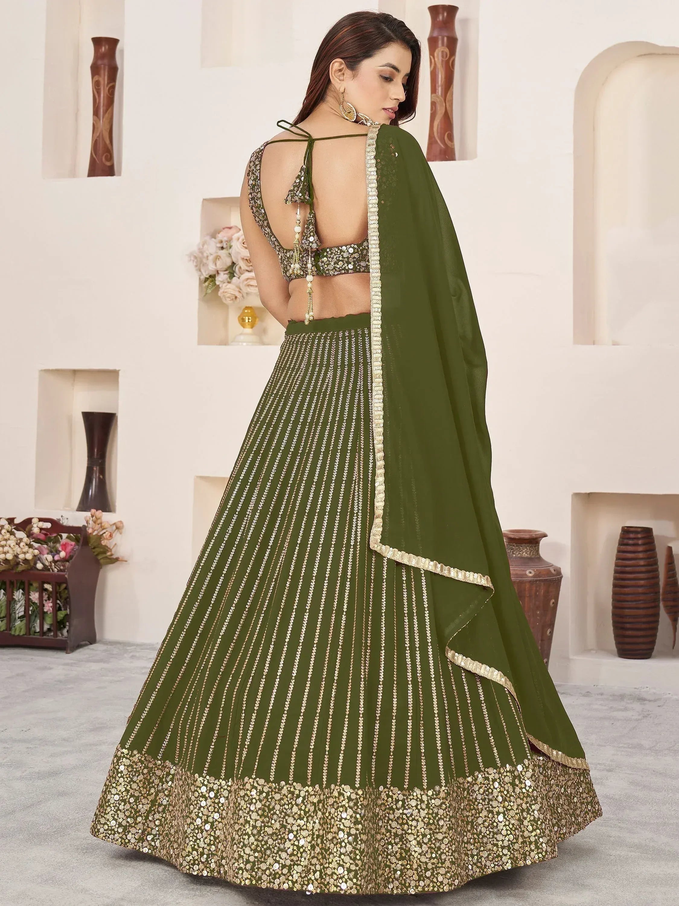 Olive green designer lehenga choli with gold embroidery and sequin work, back view