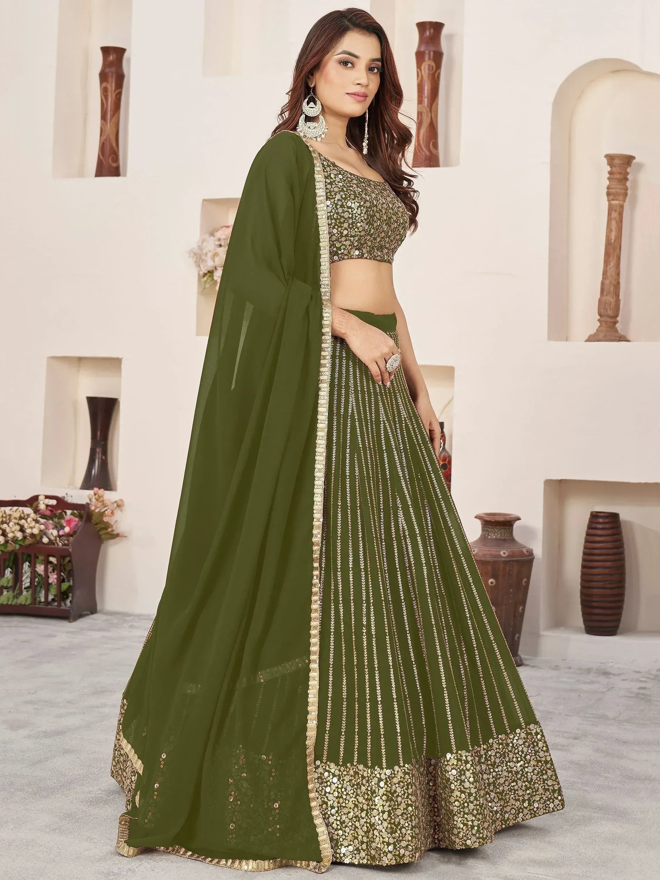 Olive green designer lehenga choli with gold sequin work and sheer dupatta, perfect for Indian ethnic occasions.