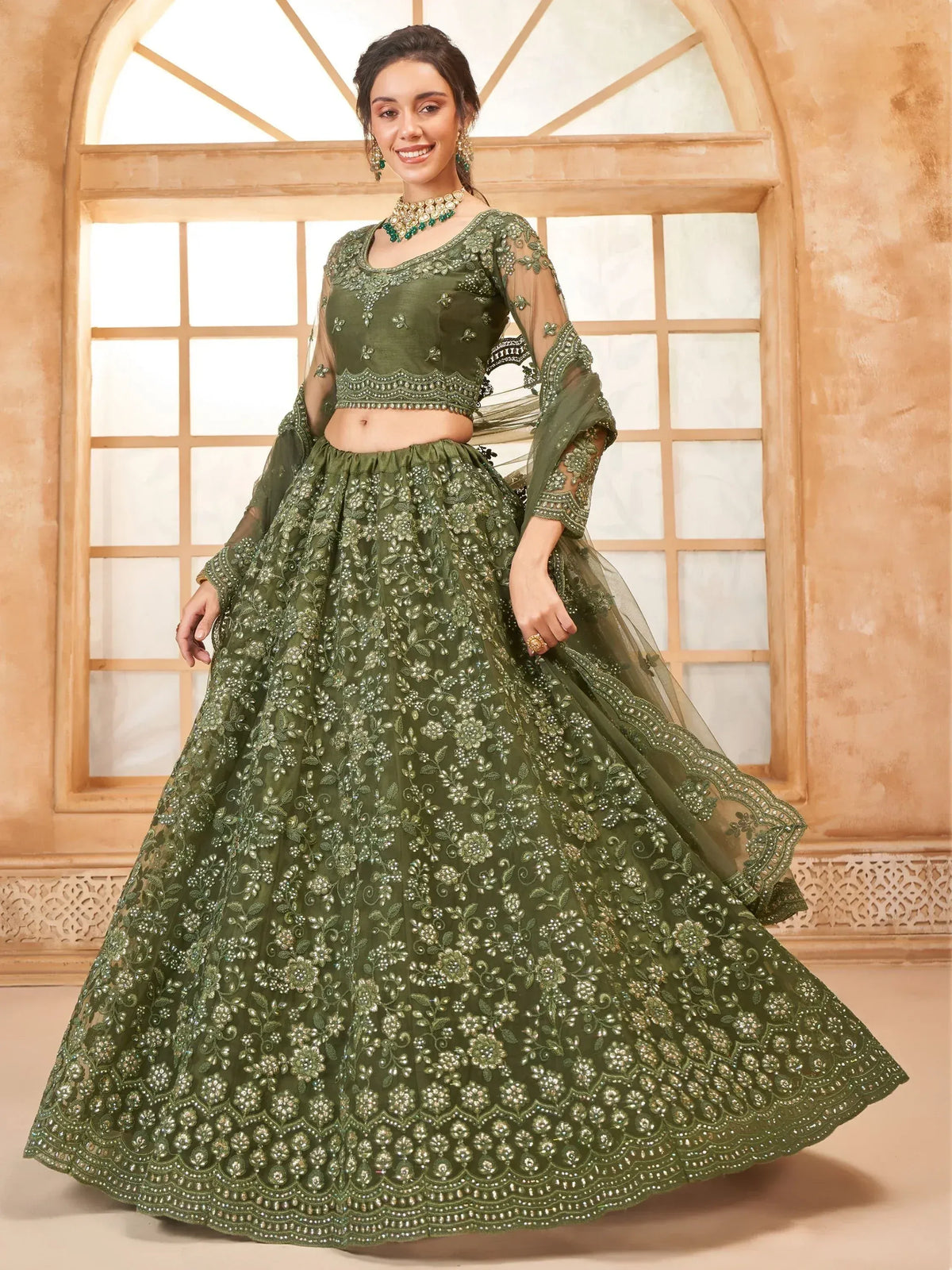 Olive green designer lehenga choli with heavy floral embroidery and sheer sleeves, perfect for weddings.