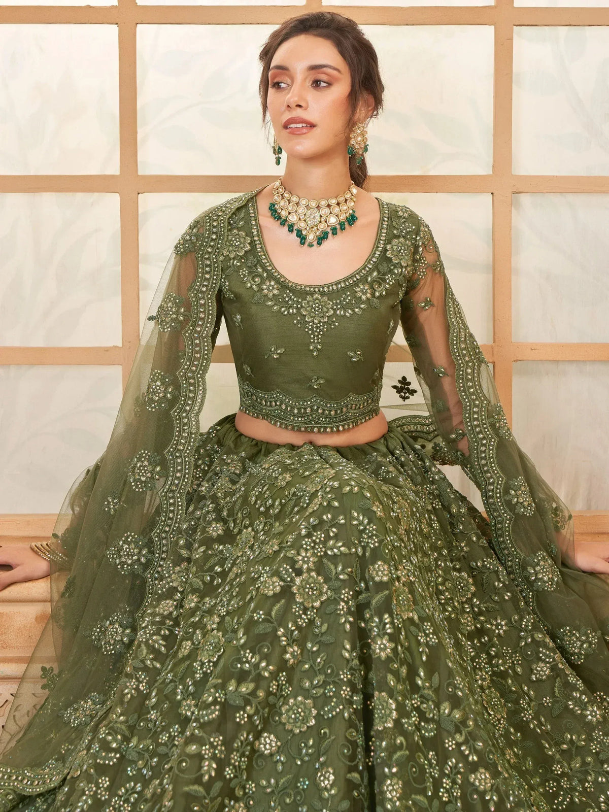 Olive green embroidered lehenga choli with sheer sleeves and floral embellishments for Indian ethnic wear
