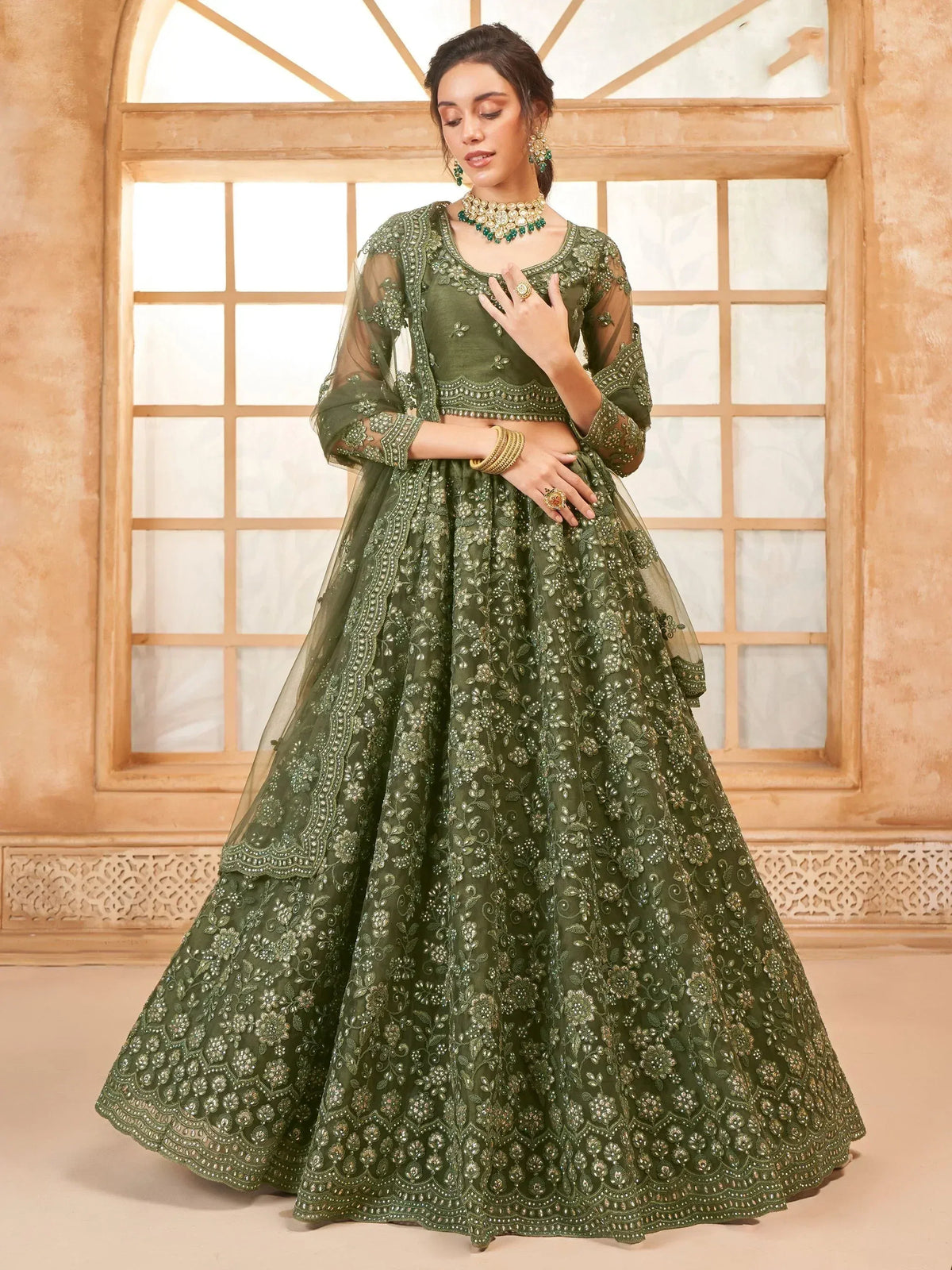 Olive green embroidered lehenga choli with sheer sleeves, perfect for Indian weddings and festive occasions.