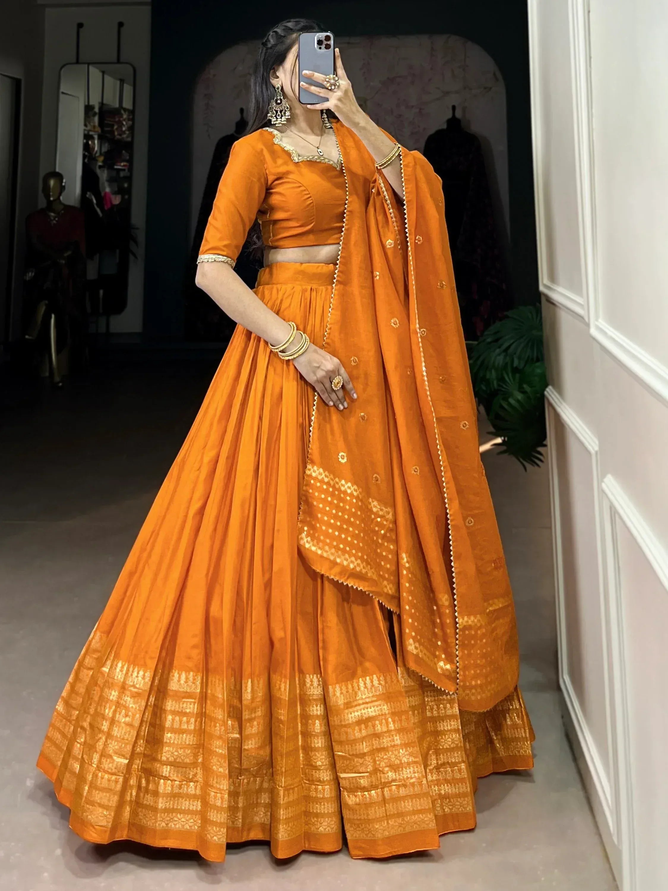 Orange designer lehenga choli with gold embroidery, perfect for Indian ethnic wear occasions