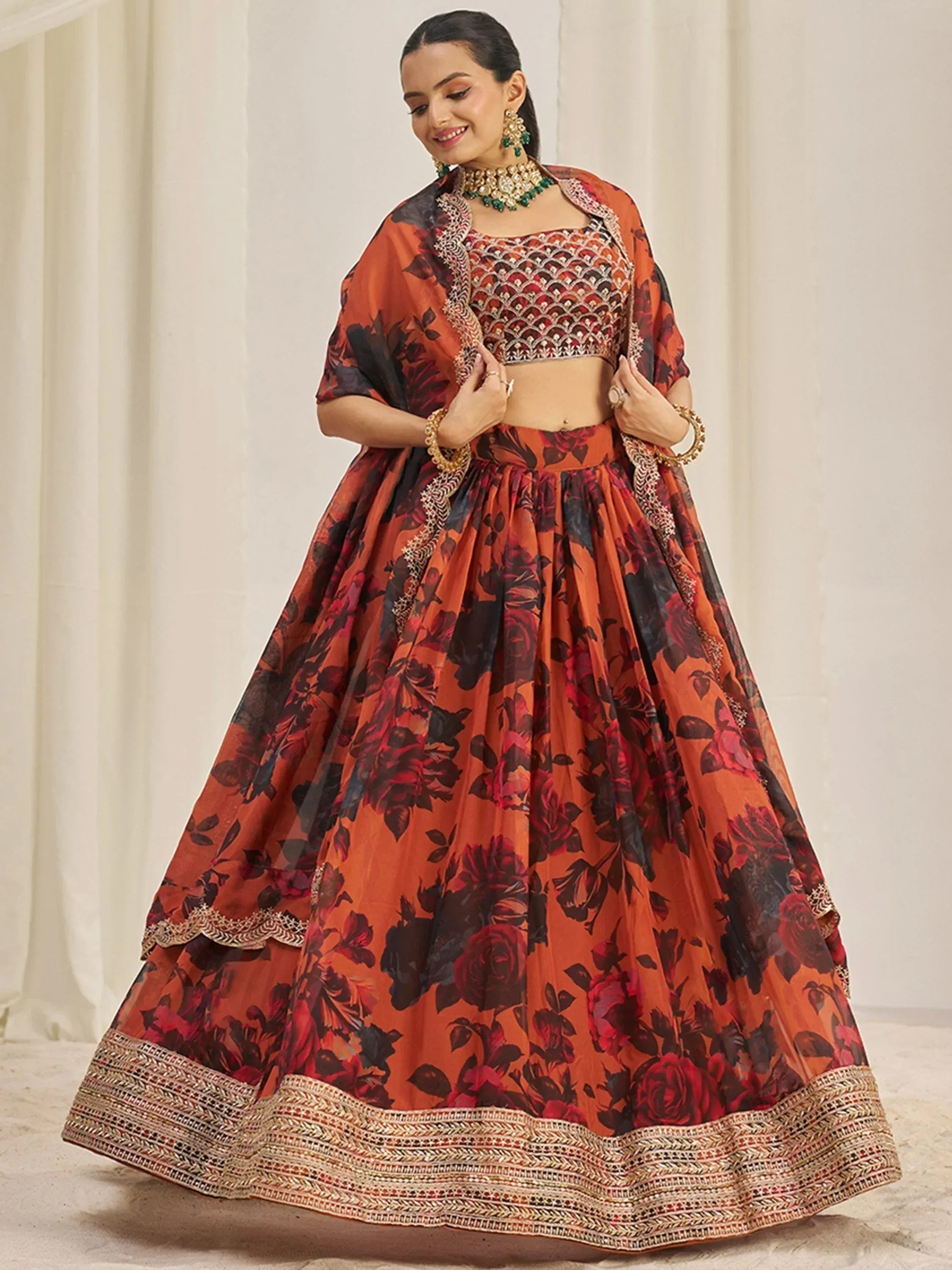 Orange floral lehenga choli with embroidered blouse and dupatta, perfect for Indian weddings and festivals