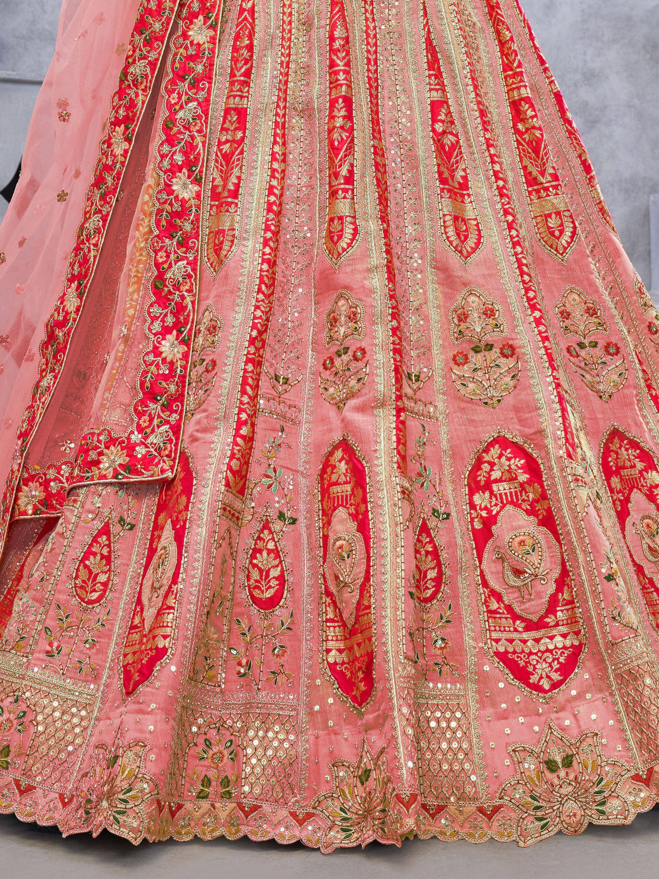 Pink and red embroidered lehenga with gold floral motifs and sequin detailing, perfect for Indian weddings.