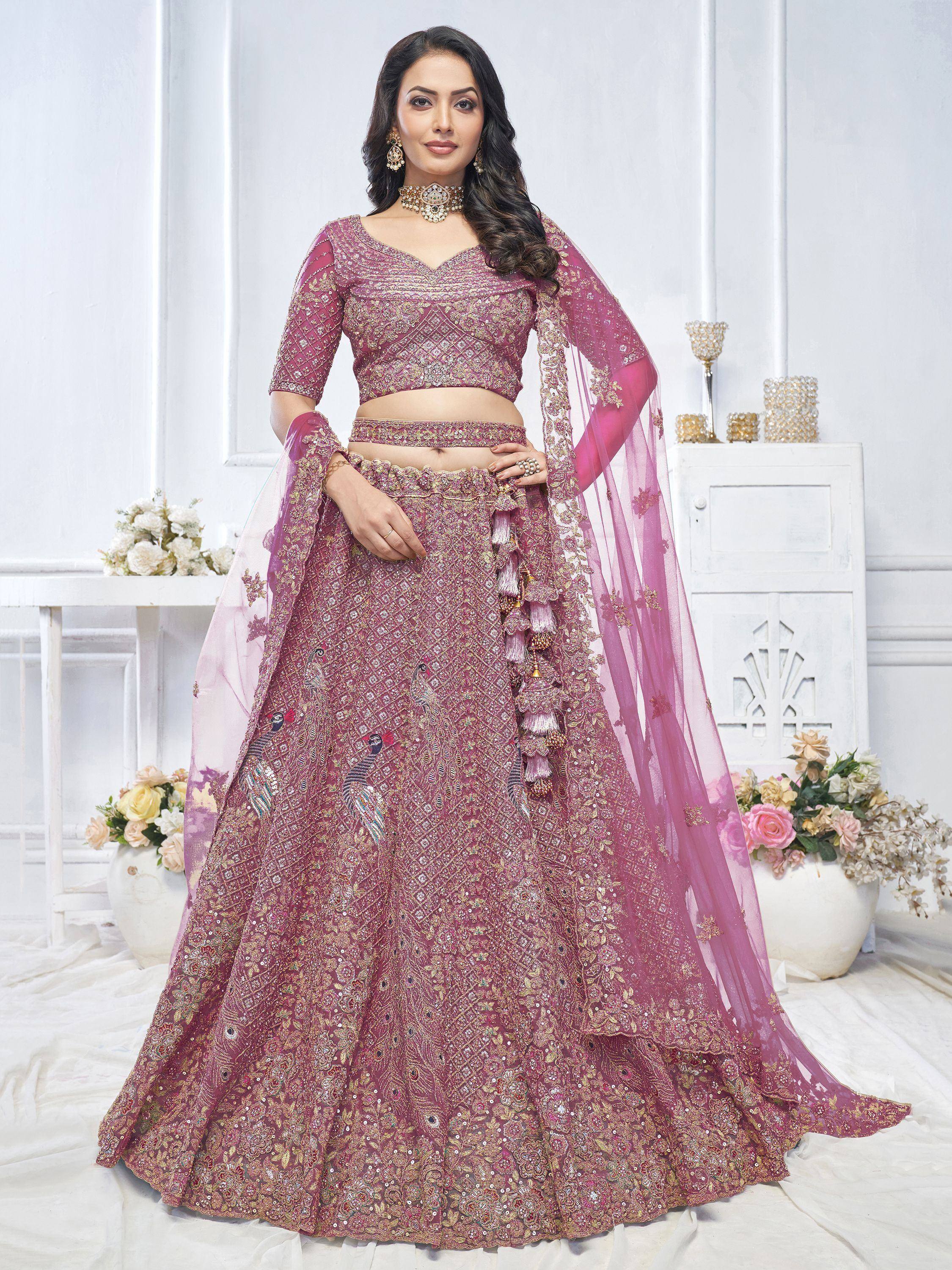 Elegant pink lehenga choli with peacock embroidery and gold detailing, perfect for Indian weddings and festive occasions.