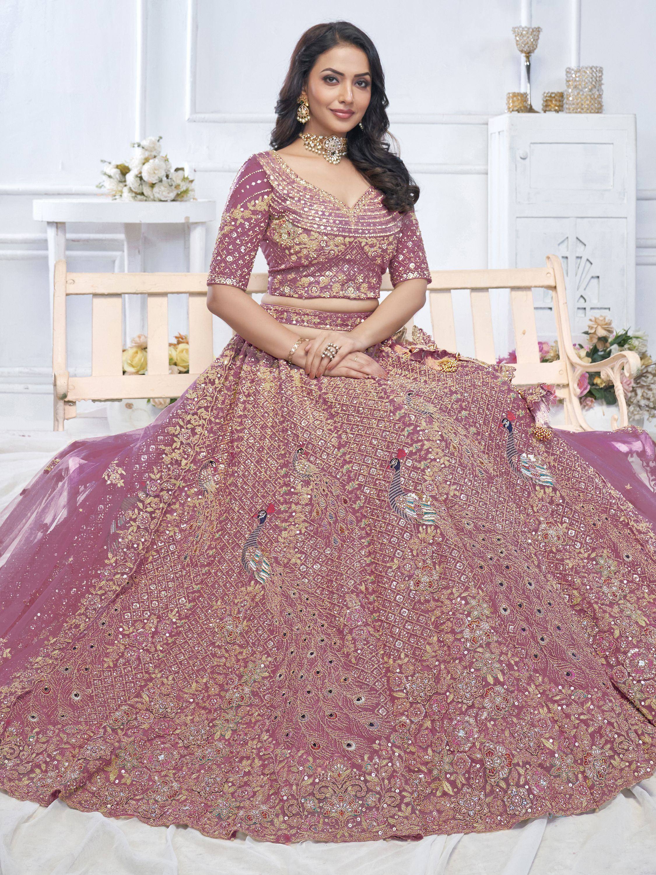 Elegant mauve lehenga choli with peacock embroidery and gold sequins, perfect for Indian weddings and festive occasions.