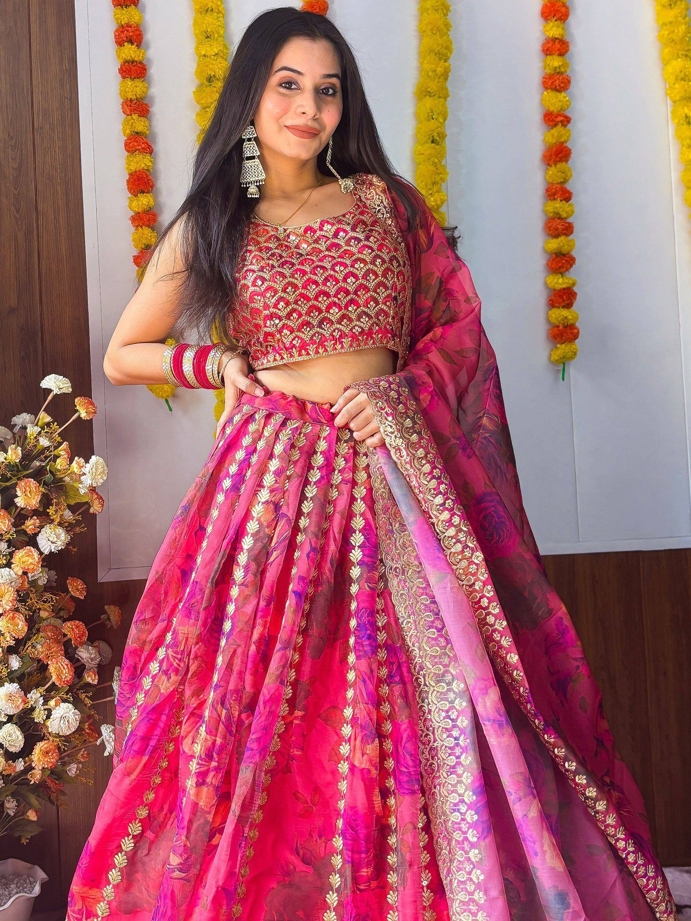 Woman in vibrant pink floral lehenga choli with gold embroidery, perfect for Indian ethnic occasions