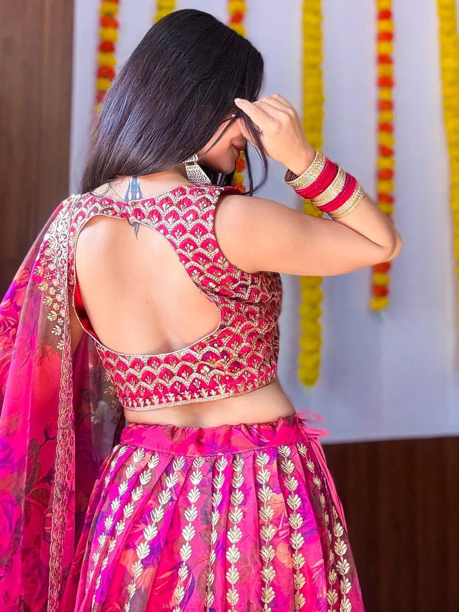 Pink embroidered lehenga choli with open back design, perfect for Indian ethnic wear occasions