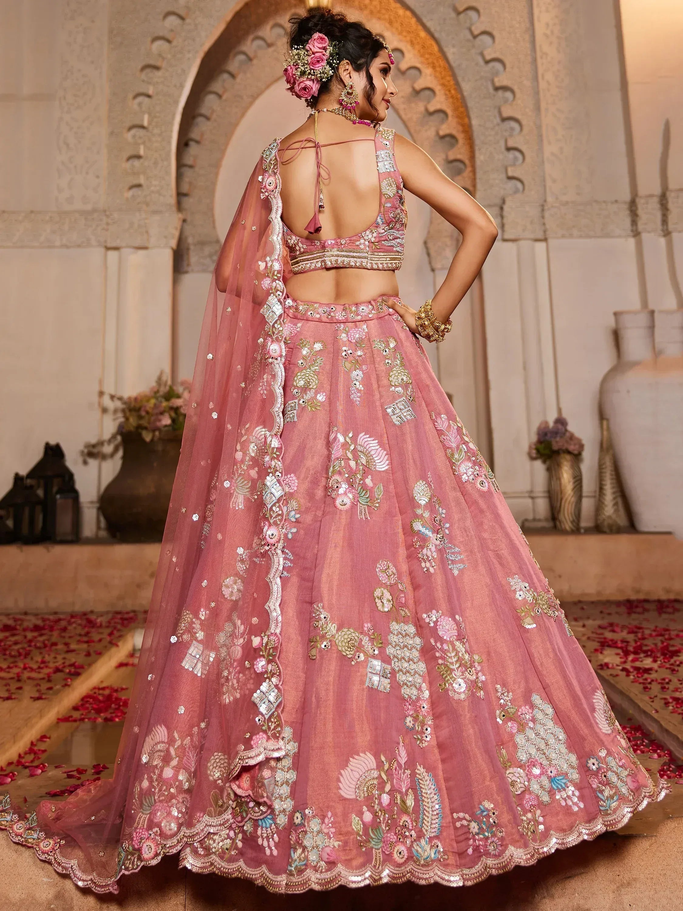 Pink embroidered lehenga choli with floral motifs, perfect for Indian weddings and festive occasions