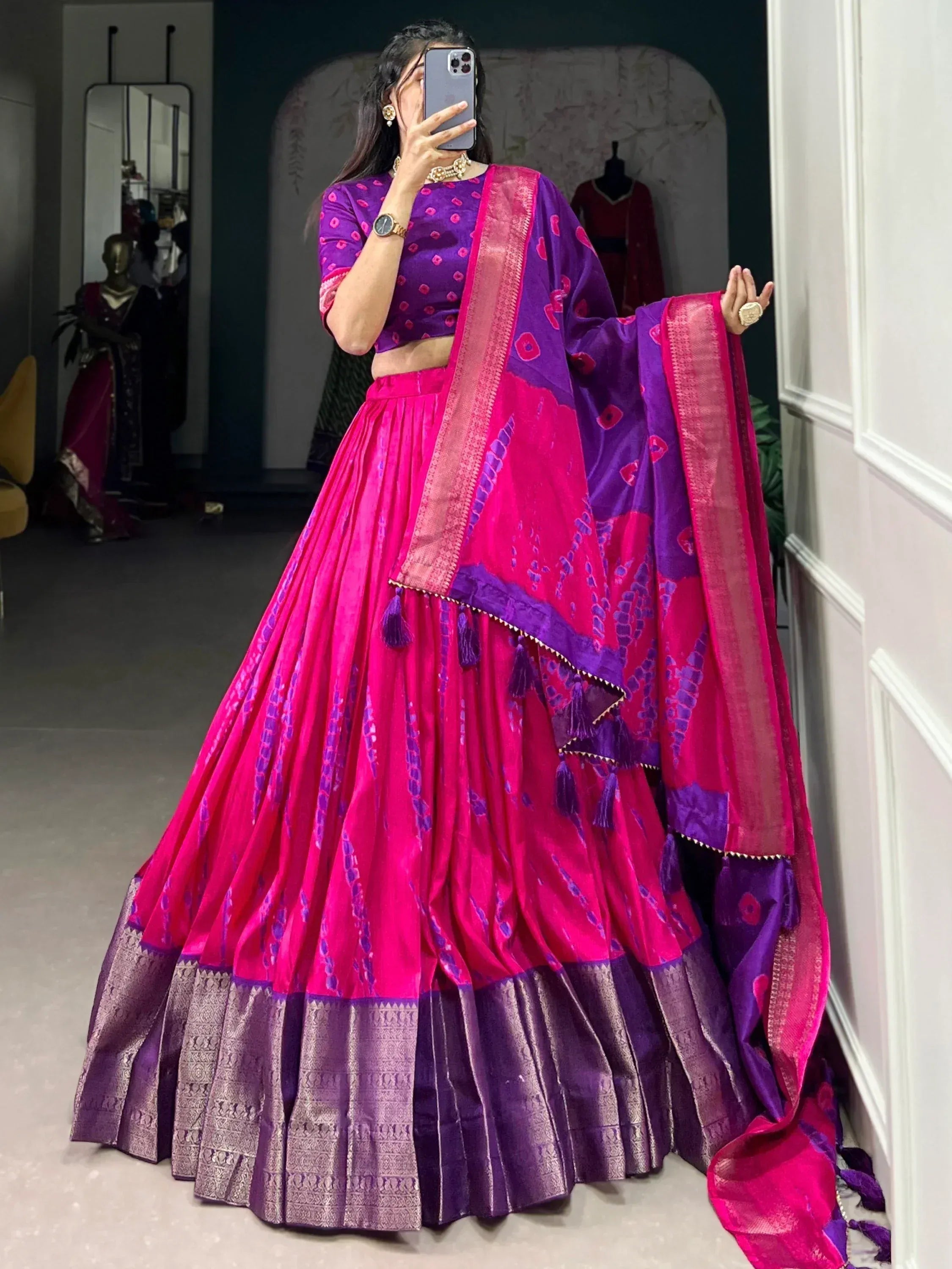 Vibrant pink and purple designer lehenga choli with embroidered dupatta, perfect for Indian ethnic wear occasions.