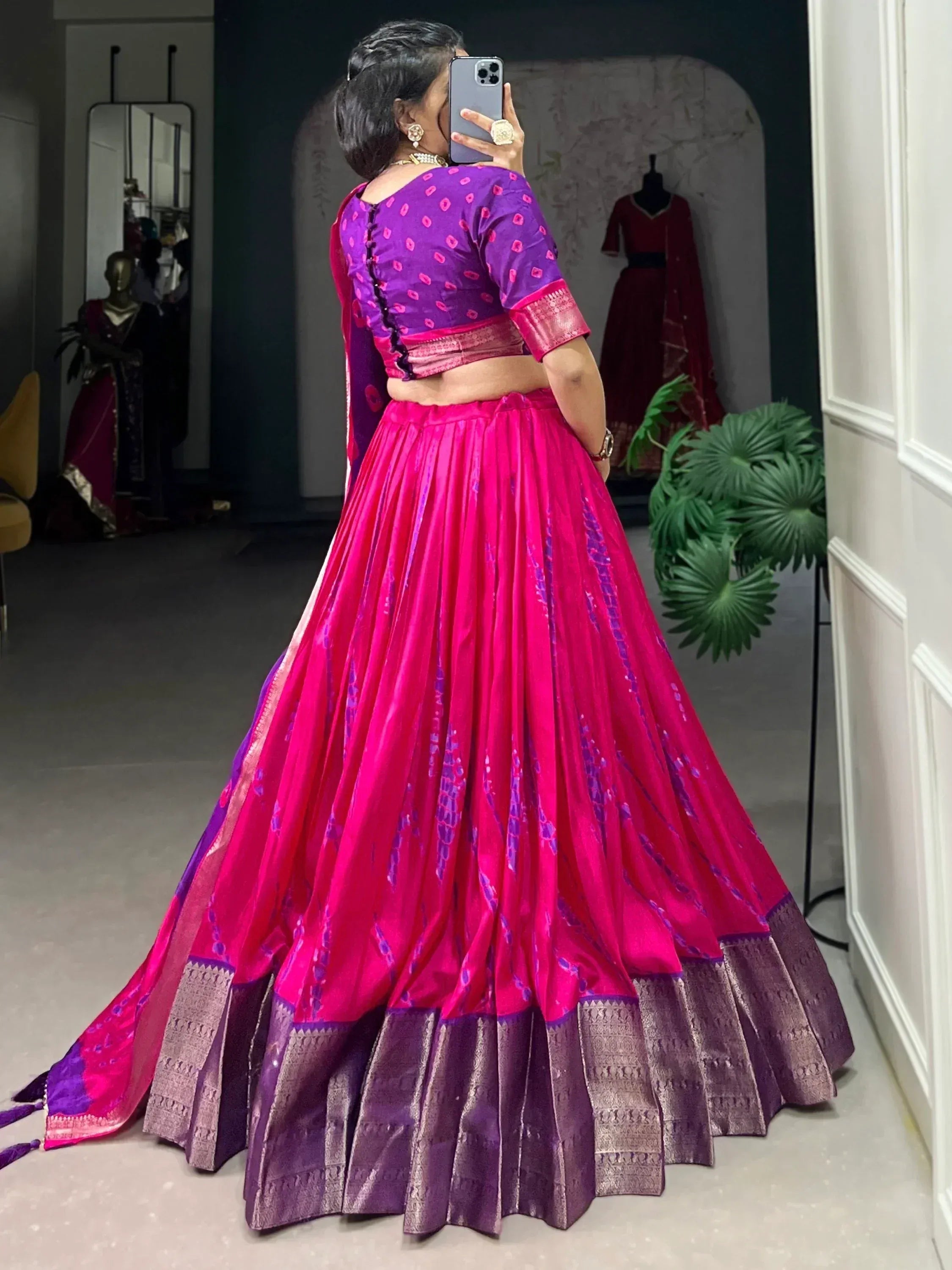 Vibrant pink and purple designer lehenga choli with intricate patterns, perfect for Indian ethnic wear occasions.