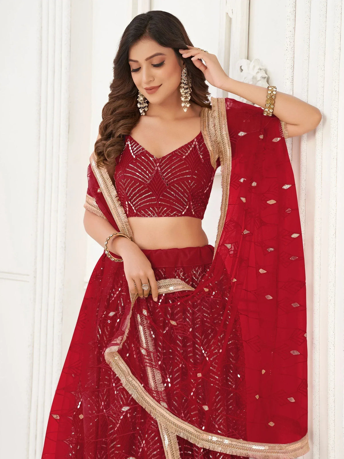 Red sequined lehenga choli with gold trim, perfect for Indian weddings and festive occasions