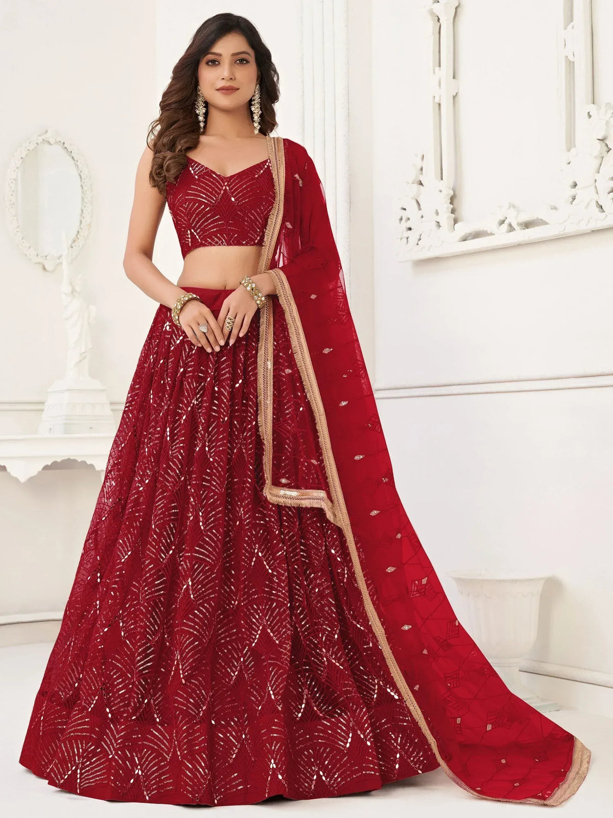 Red designer lehenga choli with gold embroidery and sequins, perfect for weddings and festive occasions