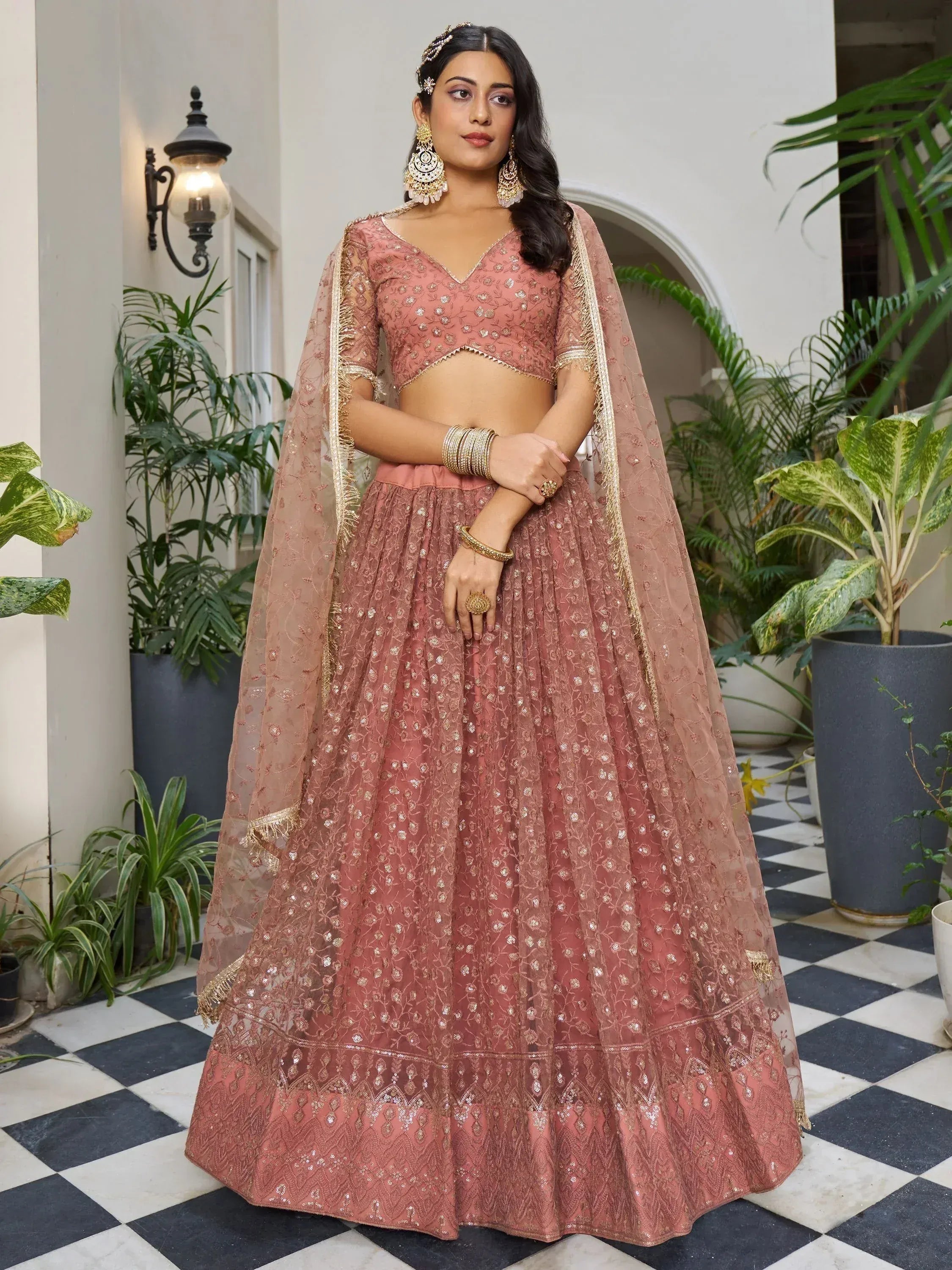 Dusty rose designer lehenga choli with gold embroidery, perfect for weddings and festive occasions.