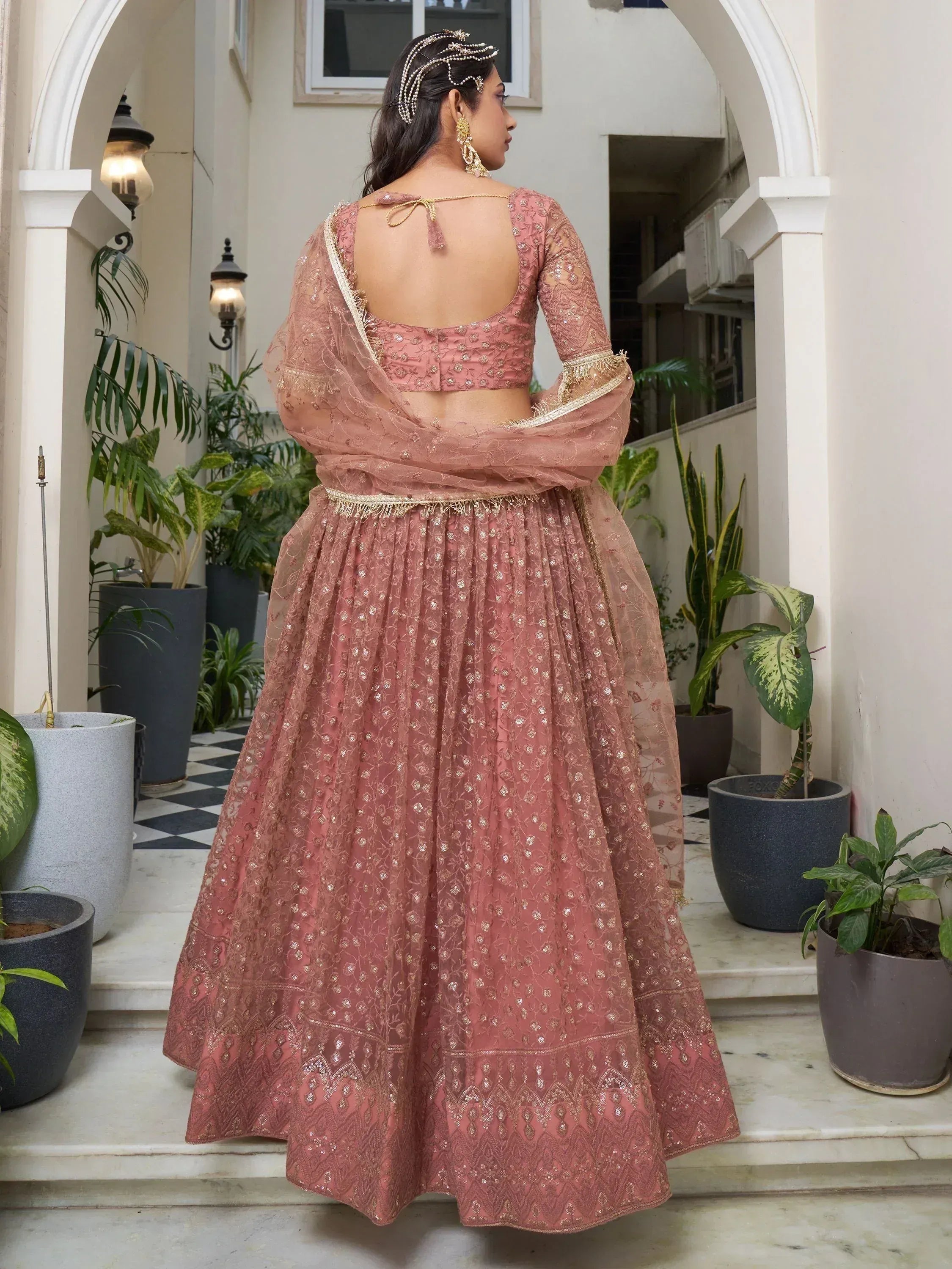 Pink embroidered lehenga choli with gold detailing, back view, perfect for Indian ethnic occasions