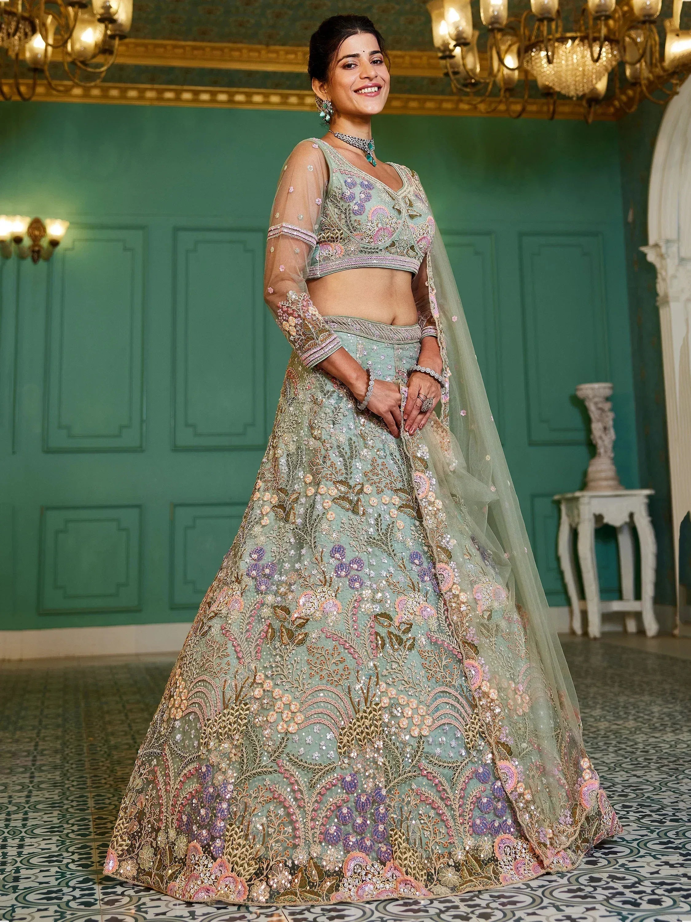 Elegant mint green lehenga choli with floral embroidery and sheer dupatta, perfect for Indian weddings and festive occasions.