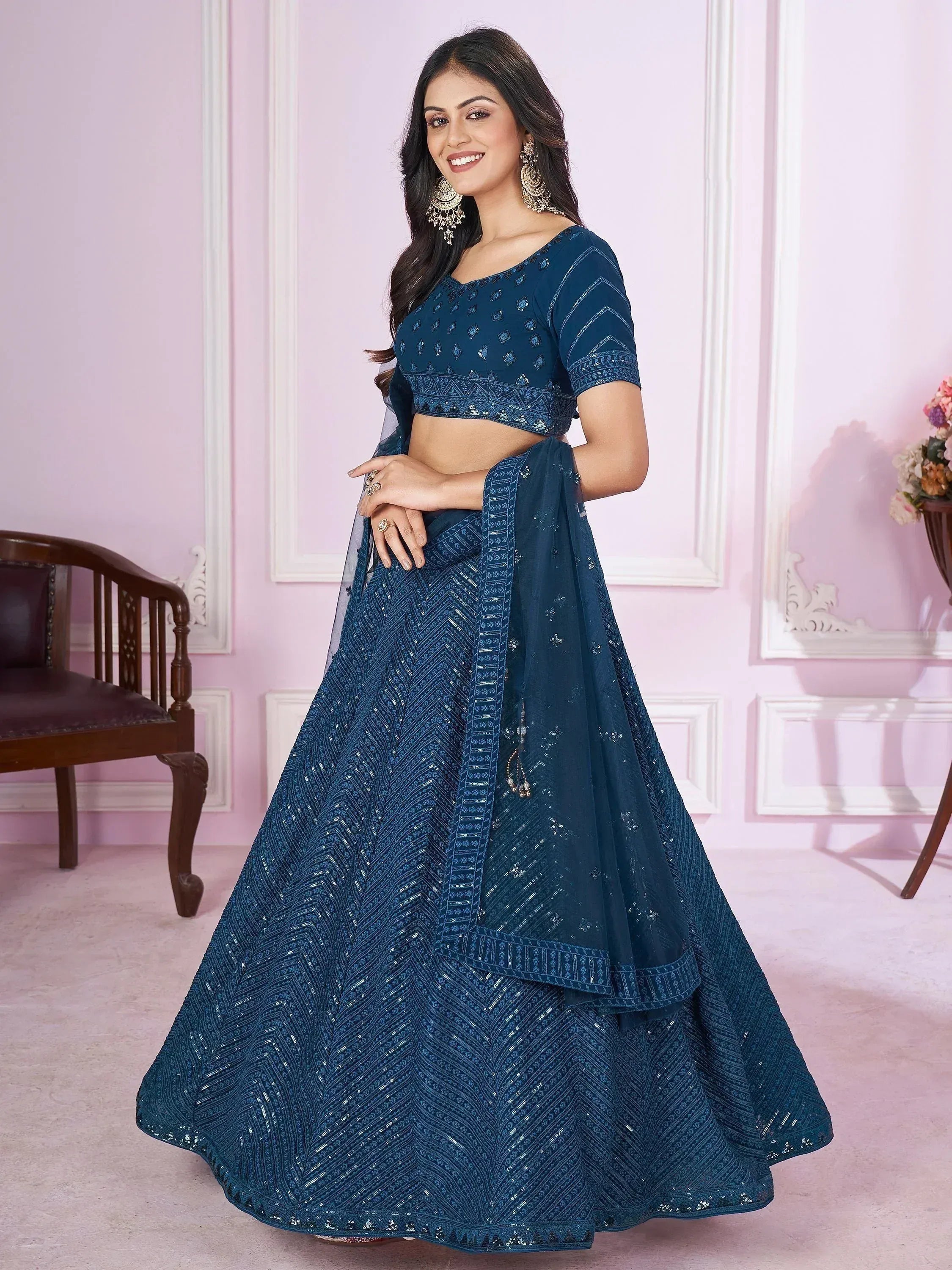 Elegant blue embroidered lehenga choli with intricate designs and matching dupatta for festive occasions