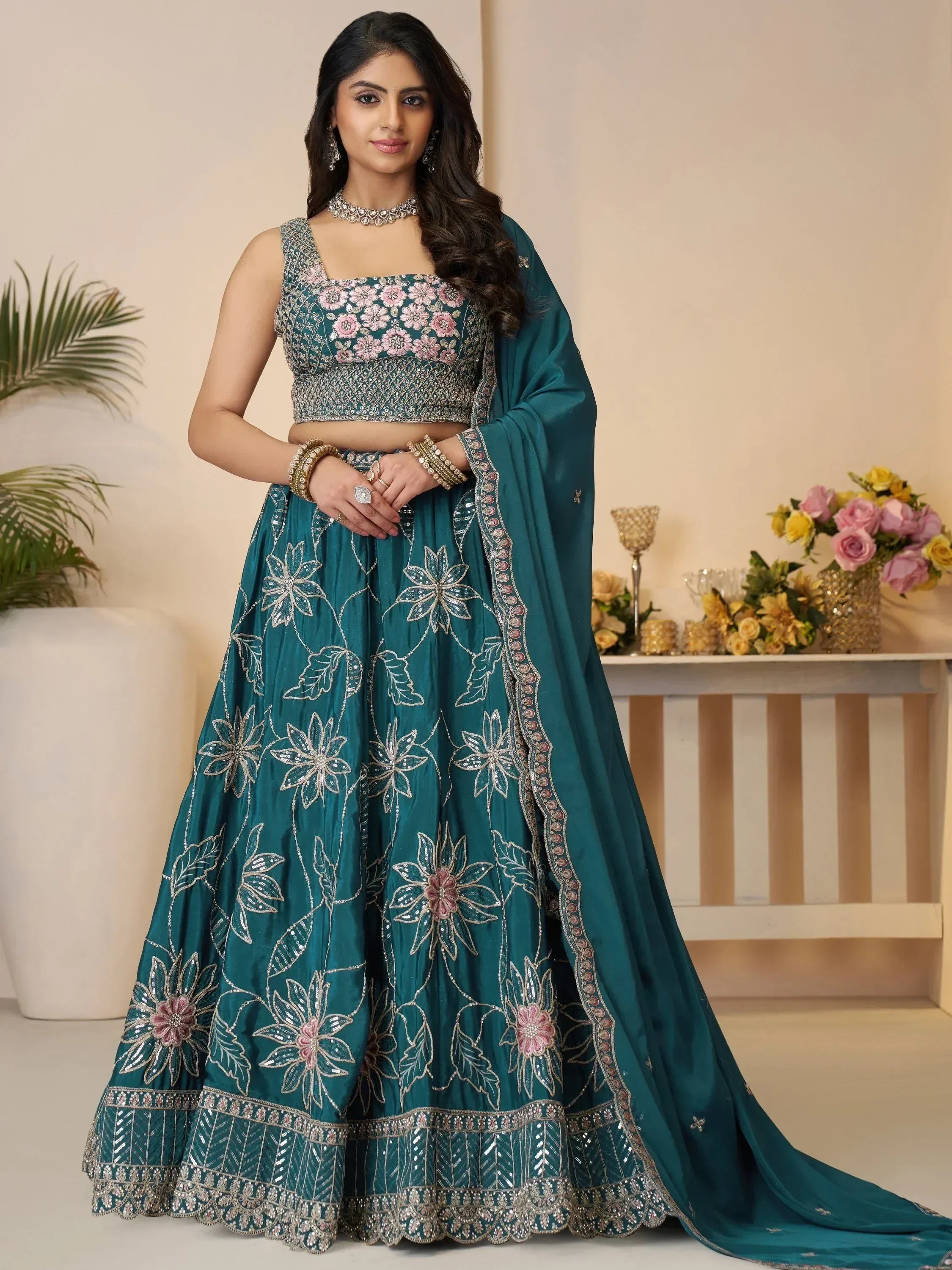 Teal floral embroidered lehenga choli with pink accents, perfect for Indian ethnic wear occasions