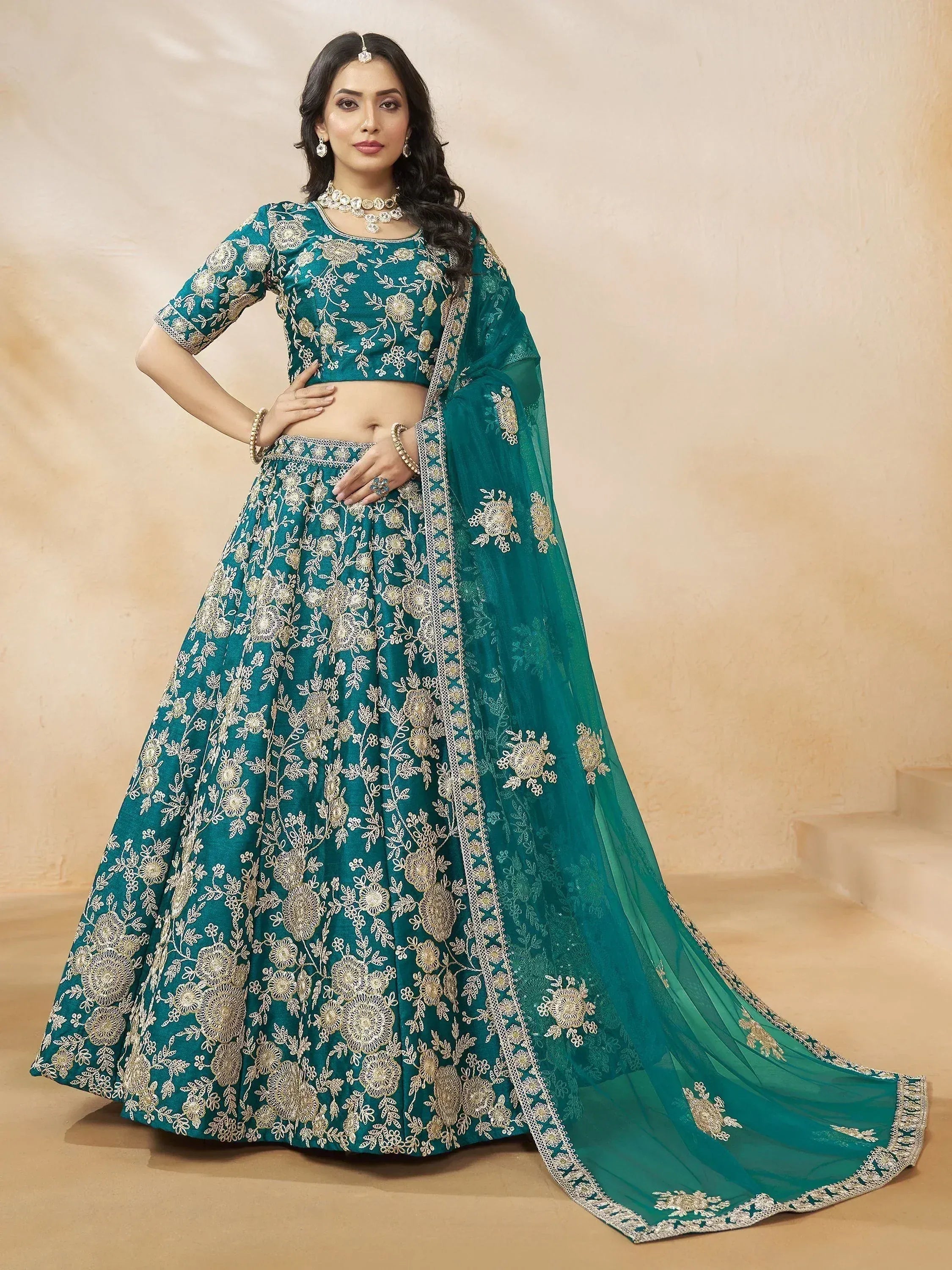 Teal designer lehenga choli with gold floral embroidery and sheer dupatta for Indian ethnic wear