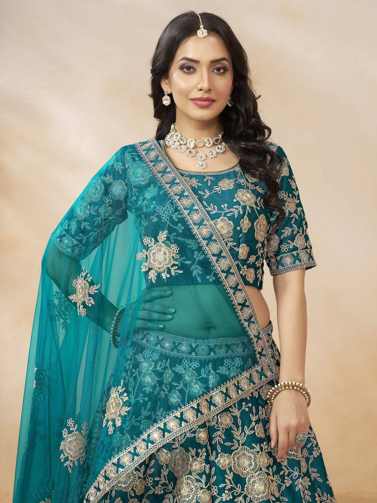 Teal embroidered lehenga choli with gold floral work, perfect for Indian ethnic wear and festive occasions.