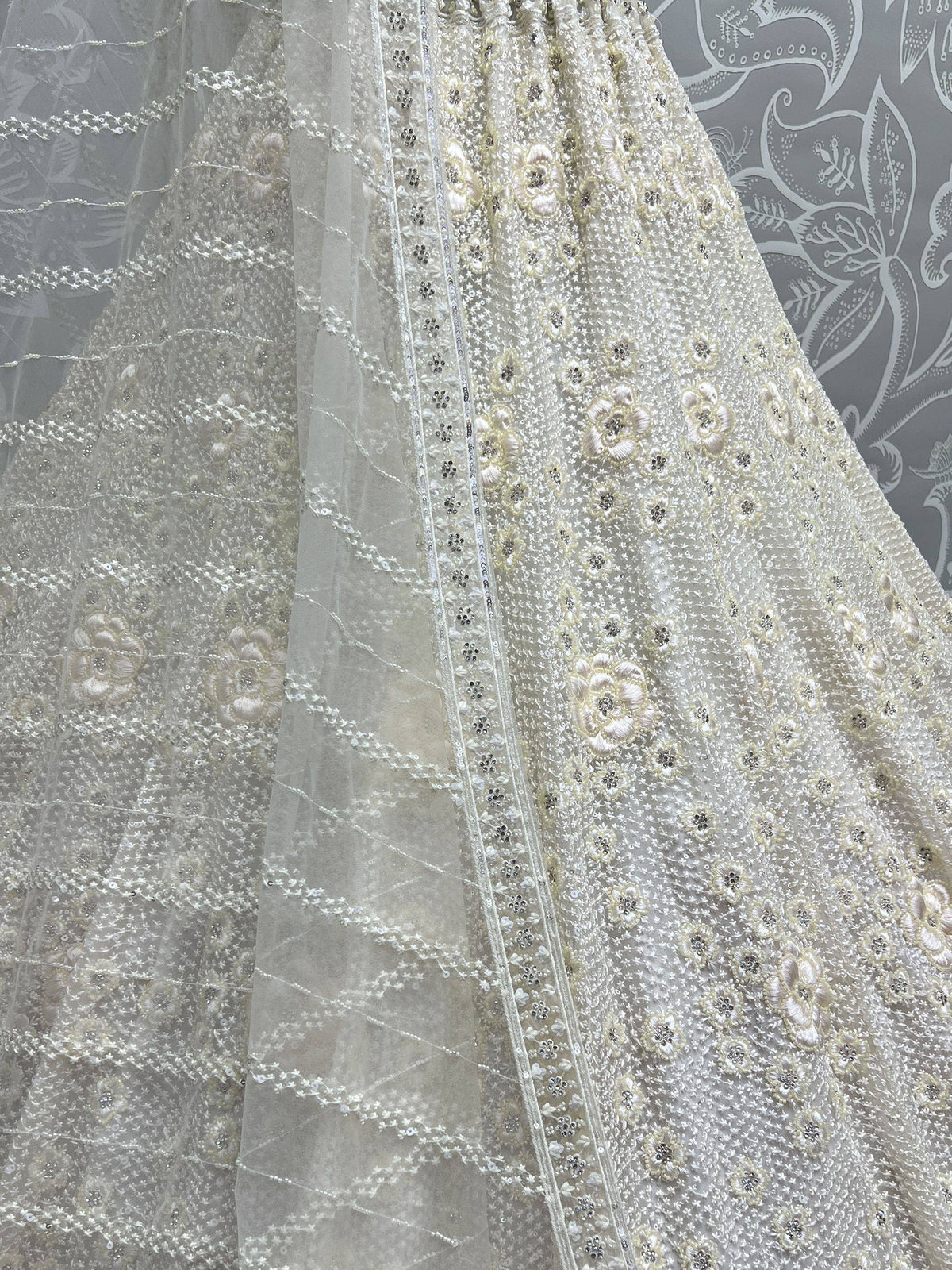 Elegant ivory lehenga with floral embroidery and sequin detailing, perfect for Indian ethnic wear.