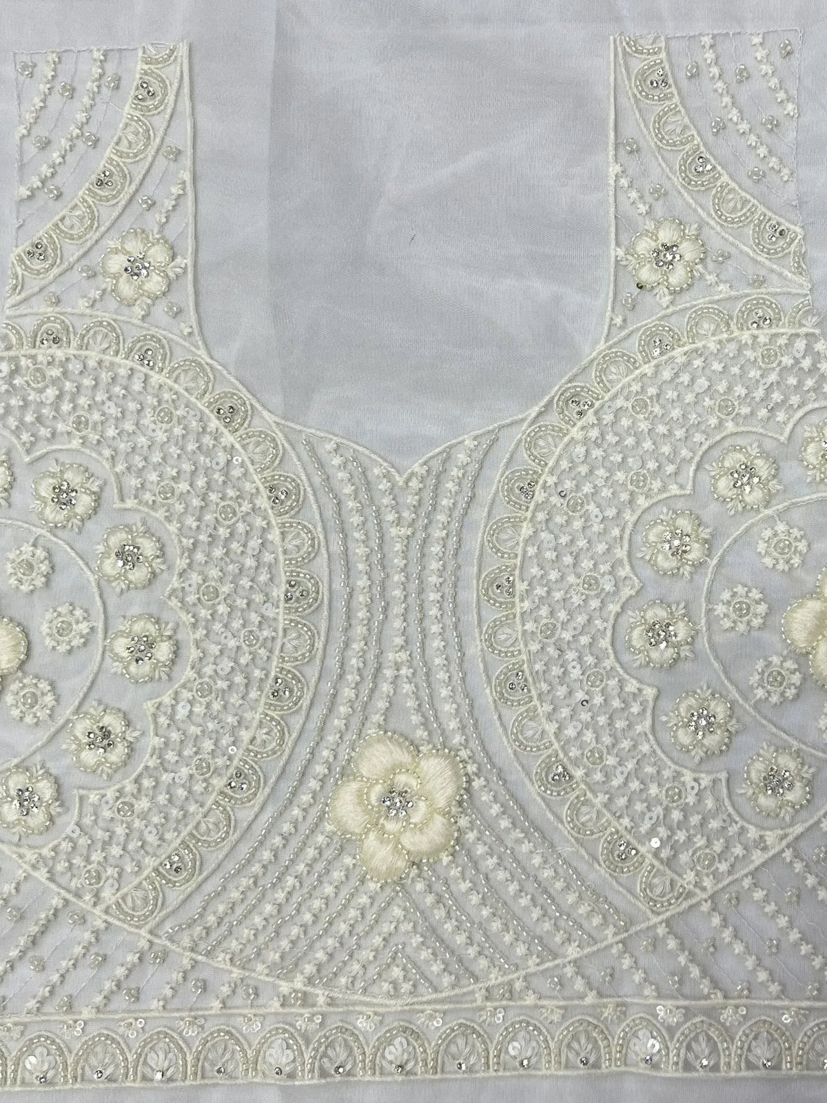 Elegant white ethnic blouse with intricate floral embroidery and sequin detailing for lehenga choli