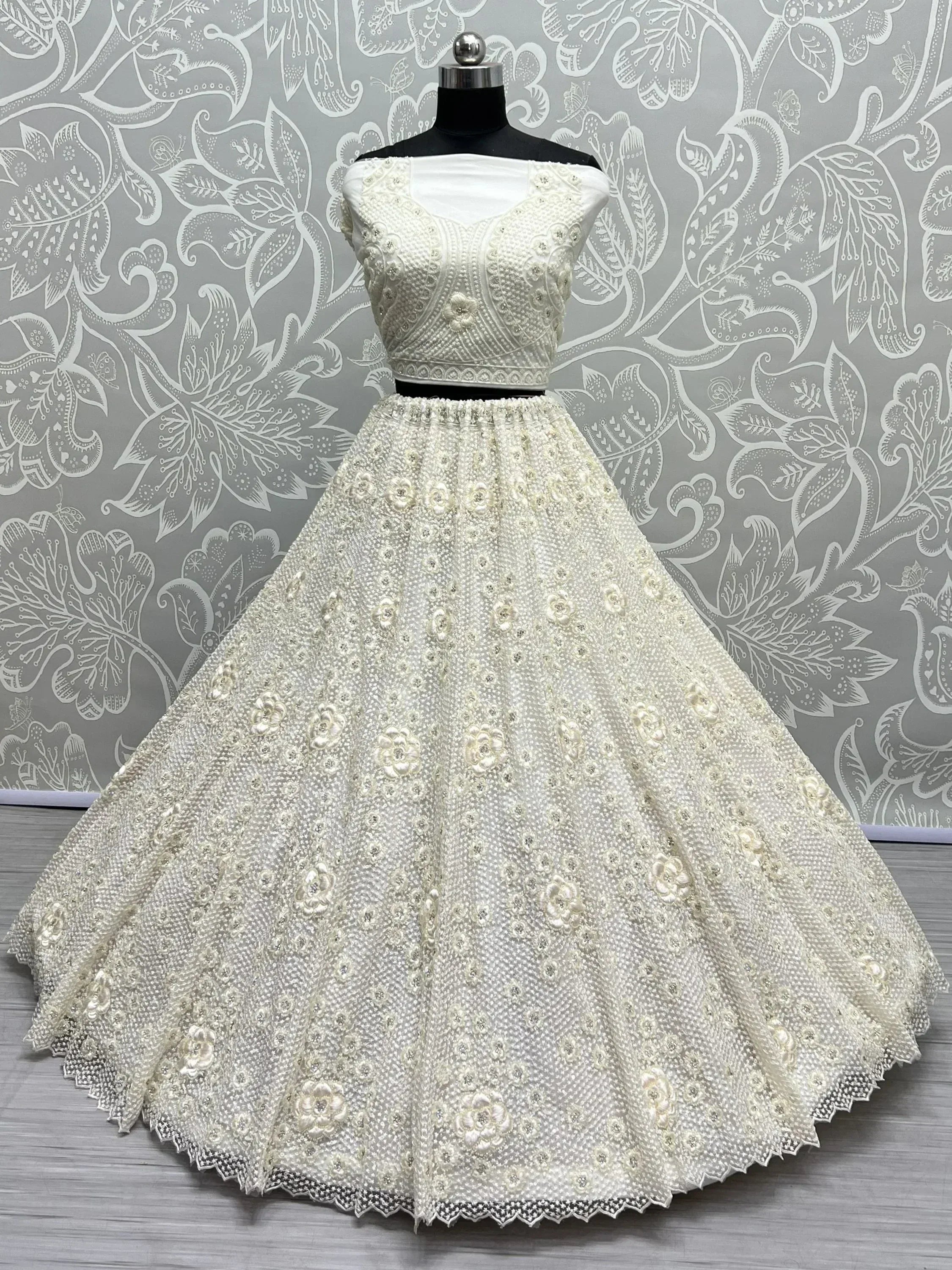 White embroidered lehenga choli with floral beadwork, perfect for Indian weddings and festive occasions.