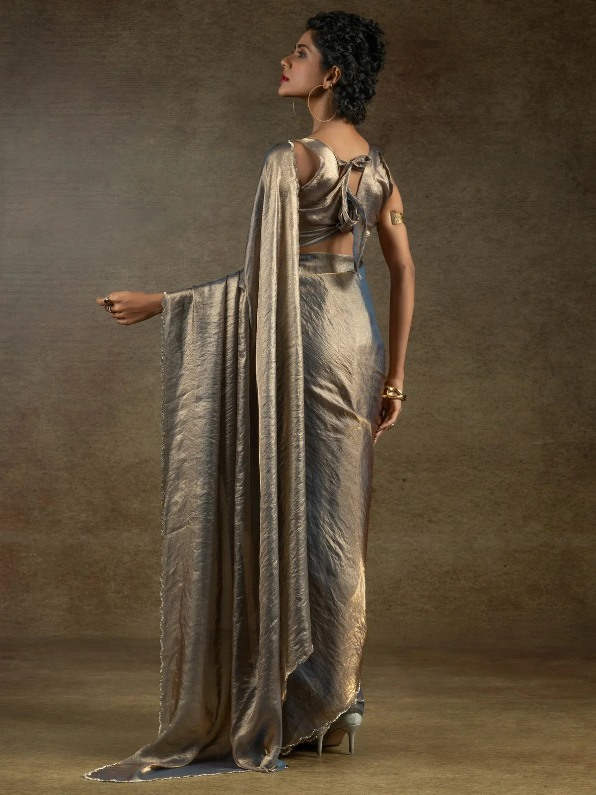 Elegant gold metallic saree with back tie blouse, perfect for Indian ethnic wear events