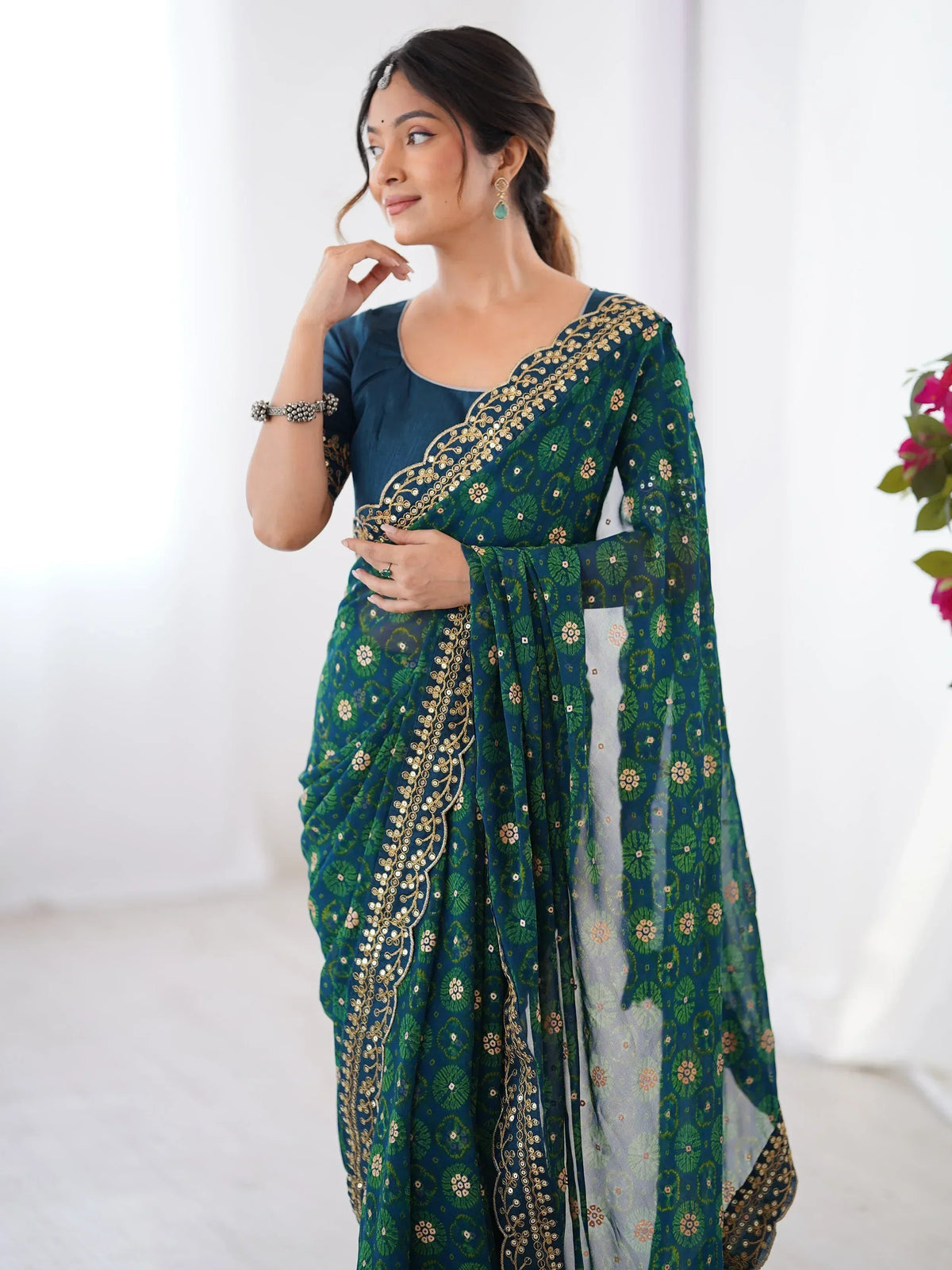 Elegant teal and green printed saree with gold embroidery, perfect for Indian ethnic wear occasions.