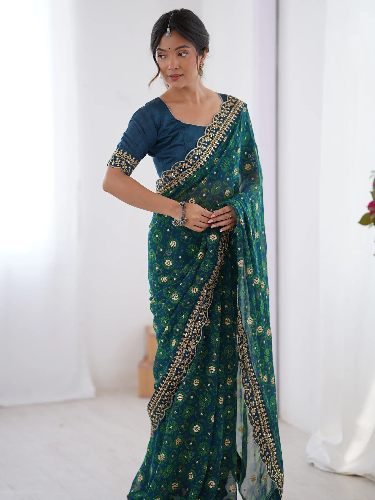 Teal and green floral saree with gold embroidery, perfect for Indian ethnic wear occasions.