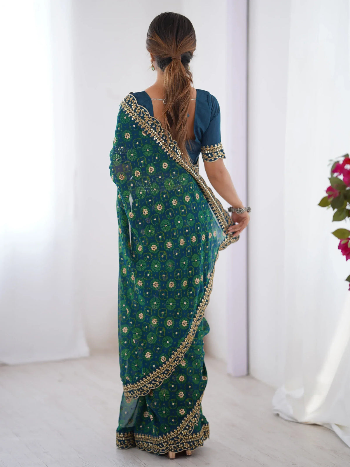Teal and green floral saree with gold embroidery, back view, ethnic wear