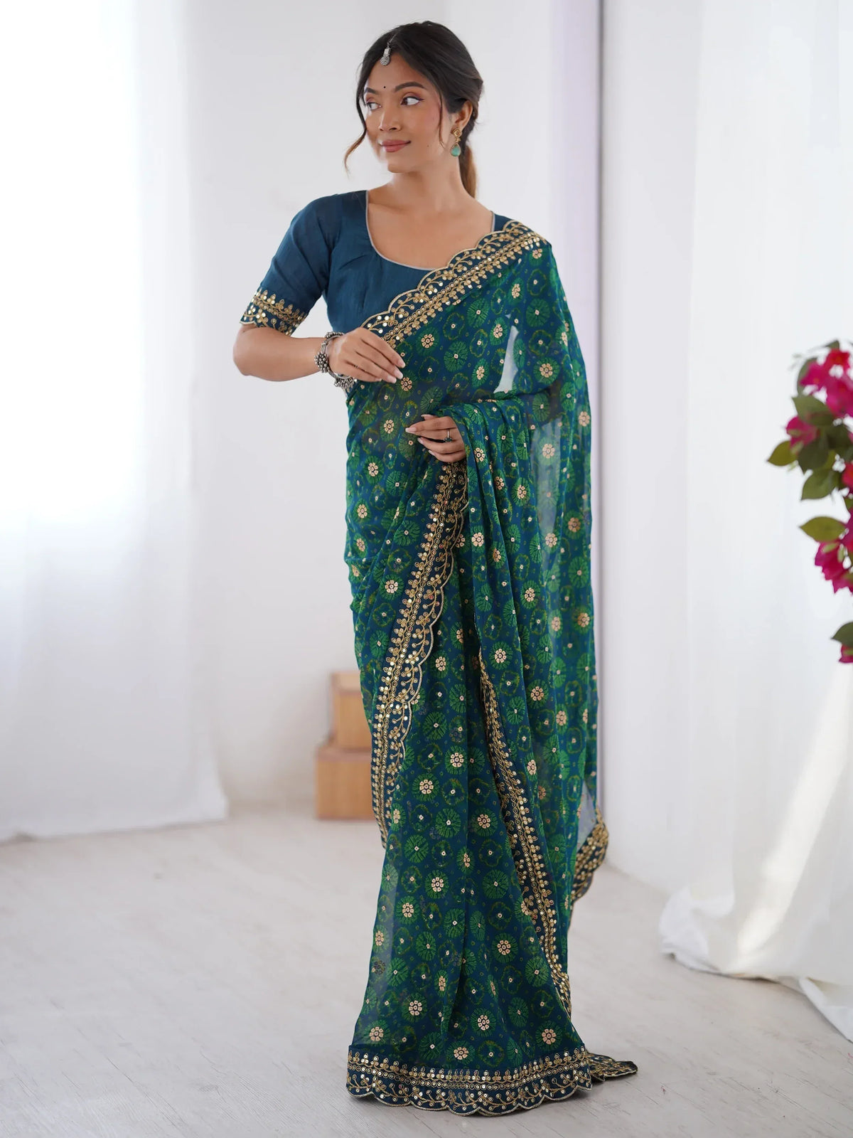 Teal green floral saree with gold embroidery and mirror work, paired with matching blouse for Indian ethnic wear