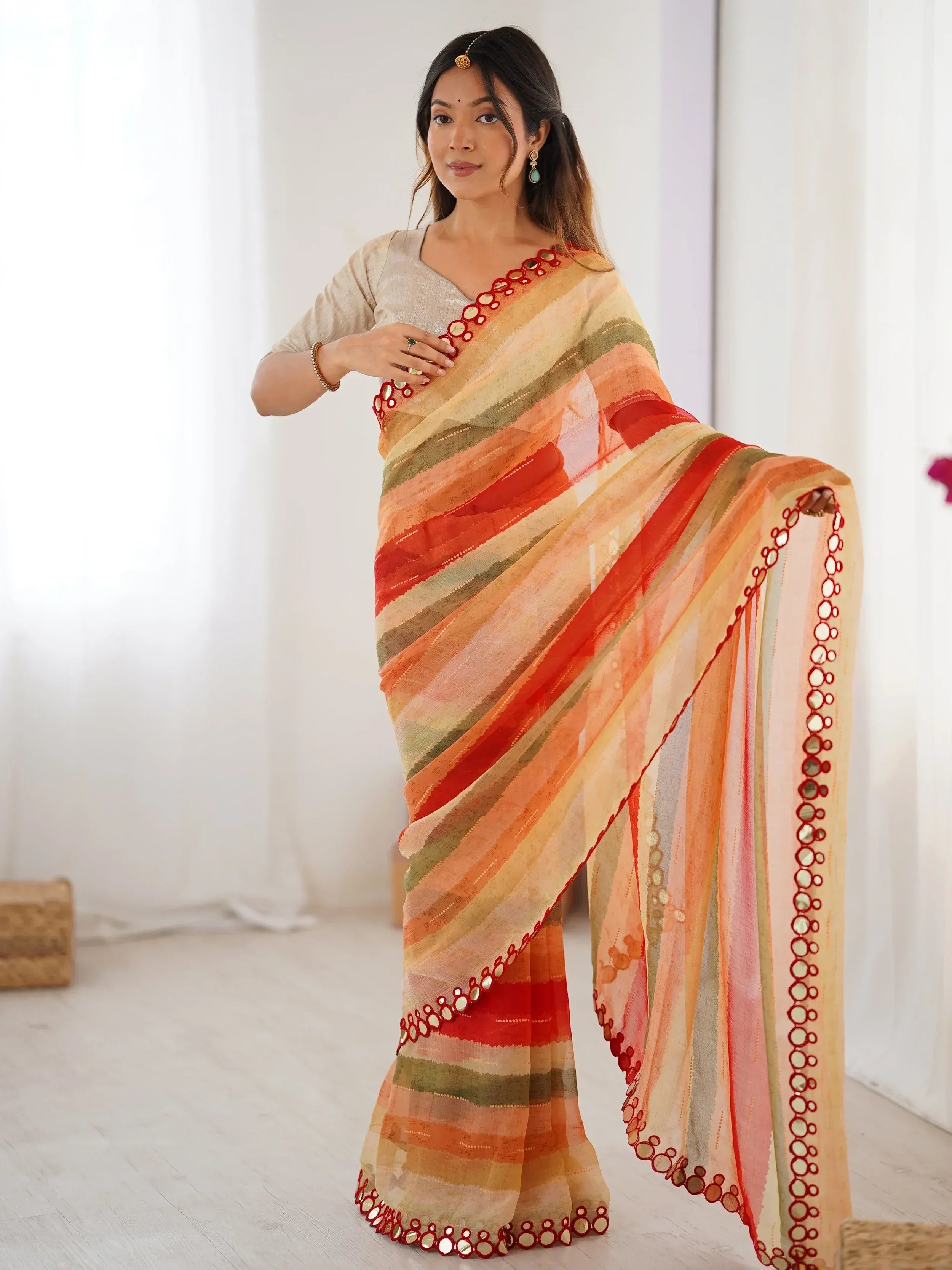 Woman in vibrant striped saree with mirror work, perfect for Indian ethnic wear occasions