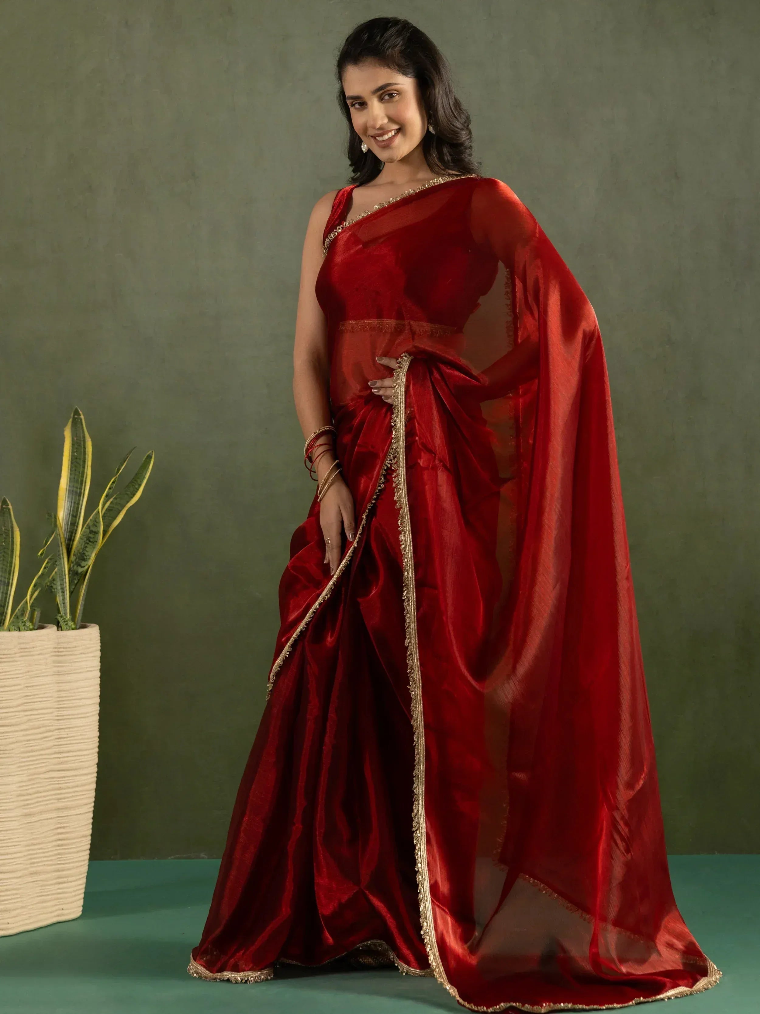 Red velvet saree with gold trim, elegant Indian ethnic wear for festive occasions