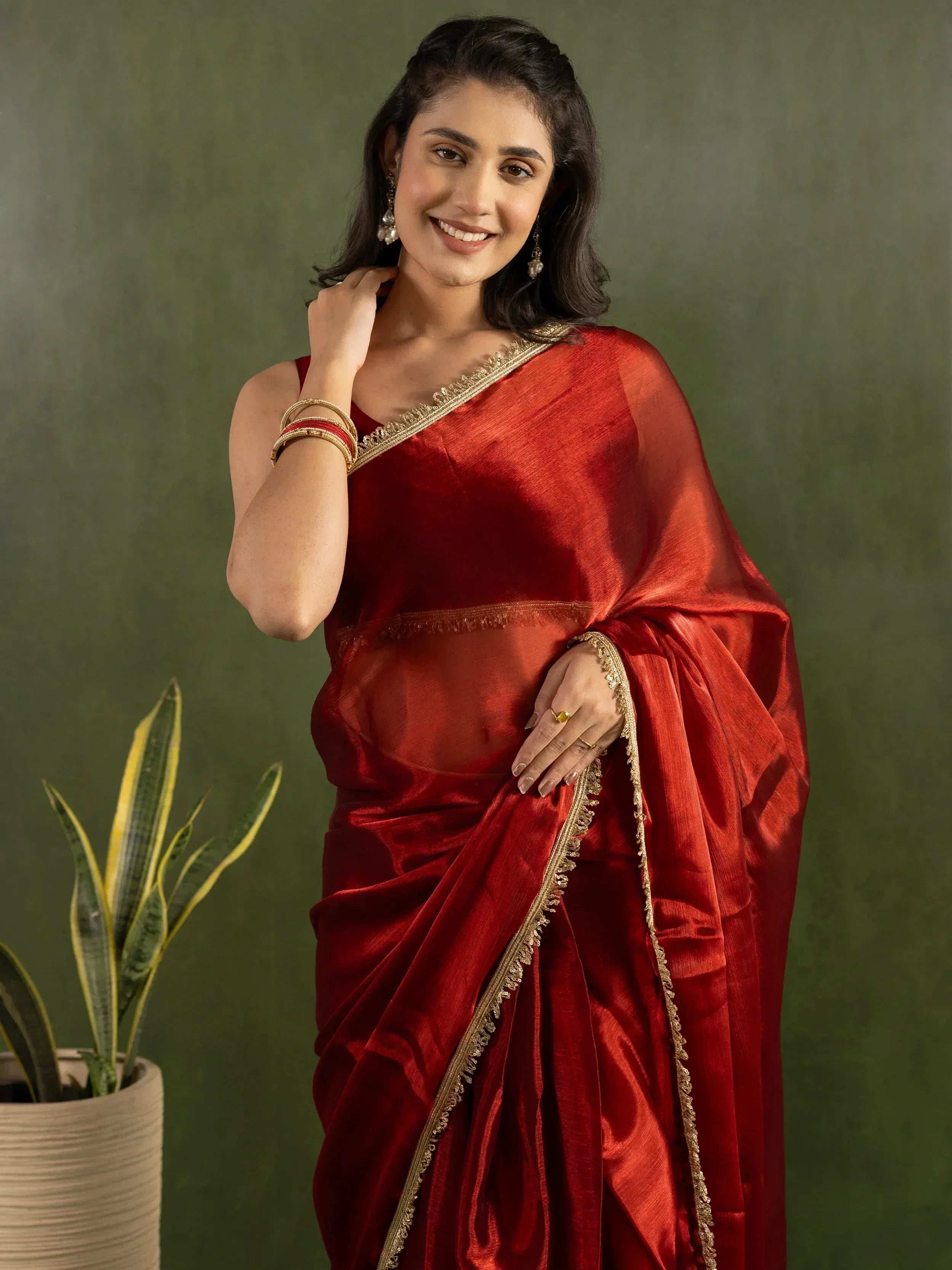 Woman in red silk saree with gold border, Indian ethnic wear for festive occasions