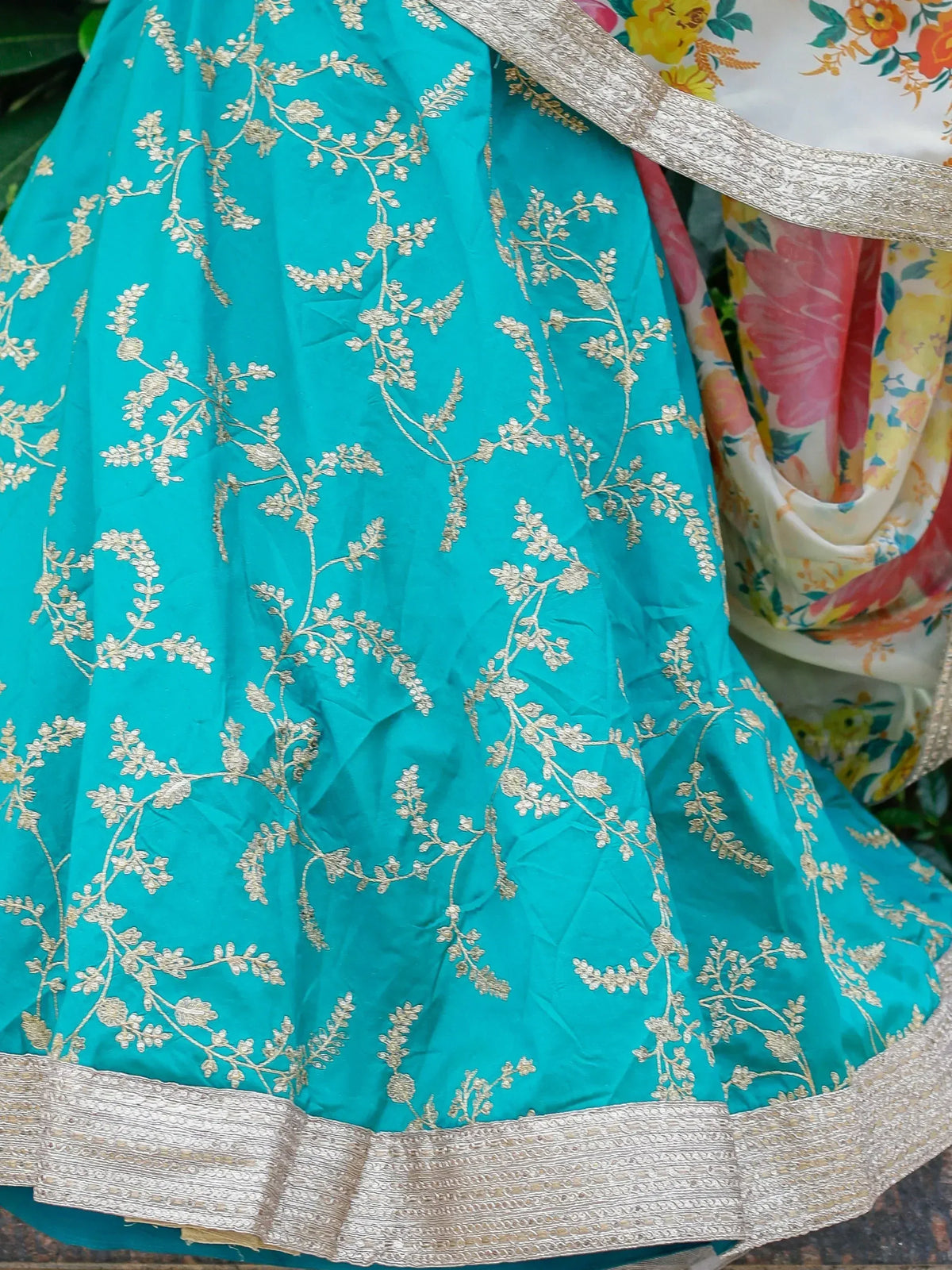 Turquoise lehenga with gold floral embroidery and silver border, paired with floral dupatta