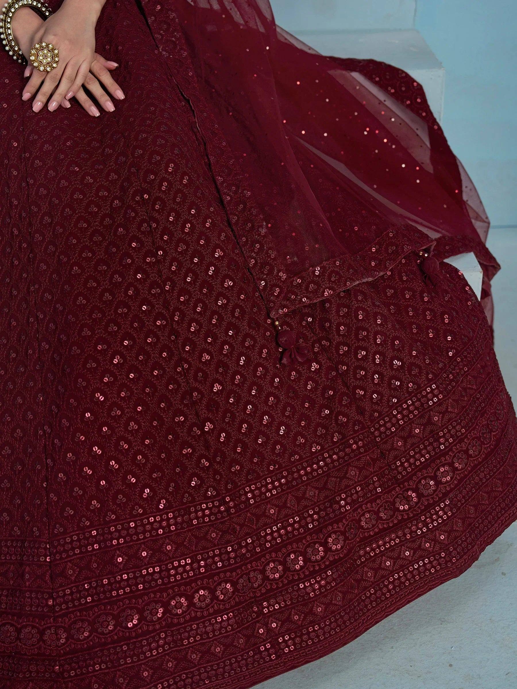 Maroon sequin-embellished lehenga with floral embroidery and sheer dupatta, perfect for Indian ethnic wear occasions.