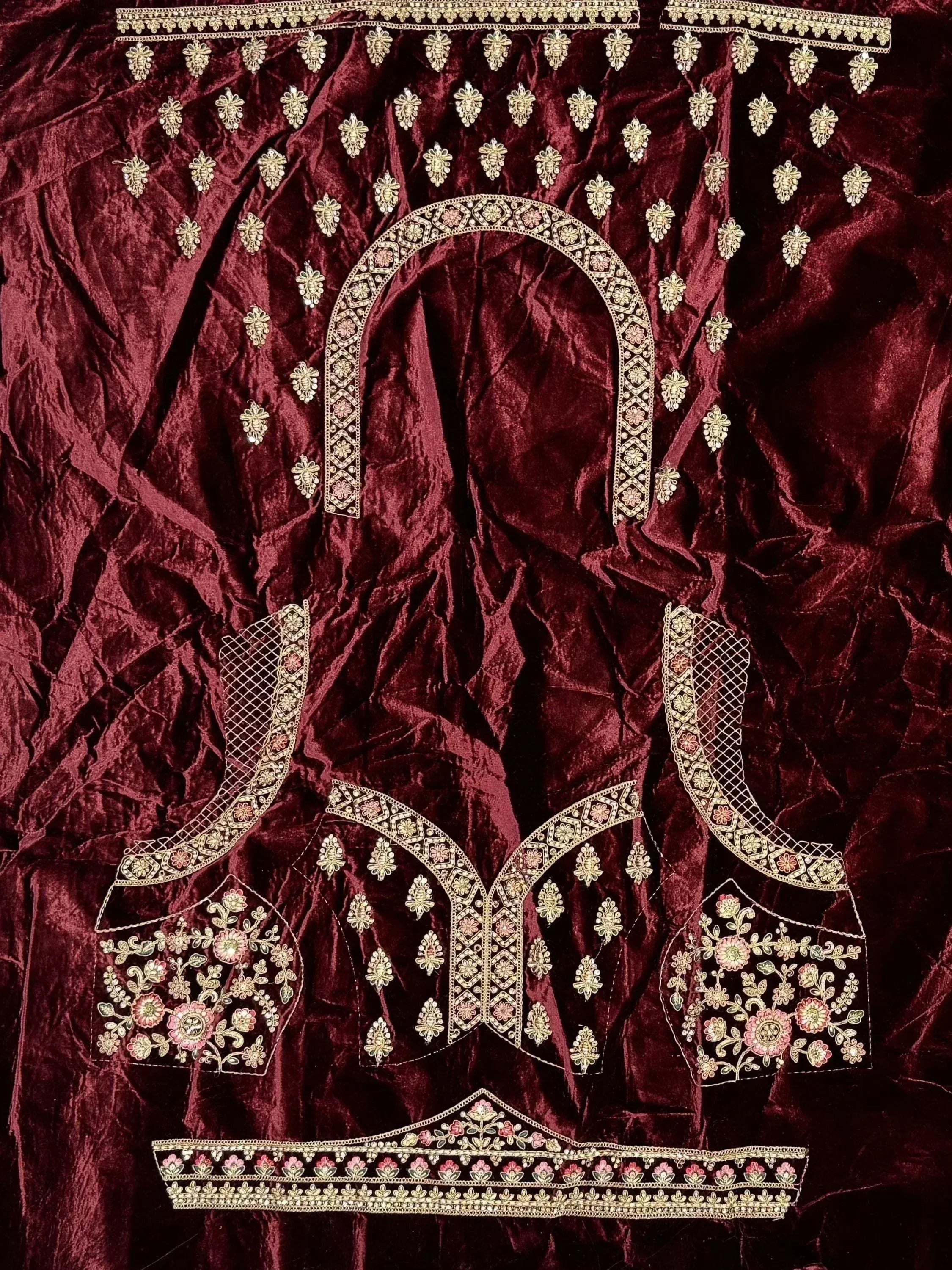 Maroon velvet designer lehenga choli with gold floral embroidery and embellished neckline details