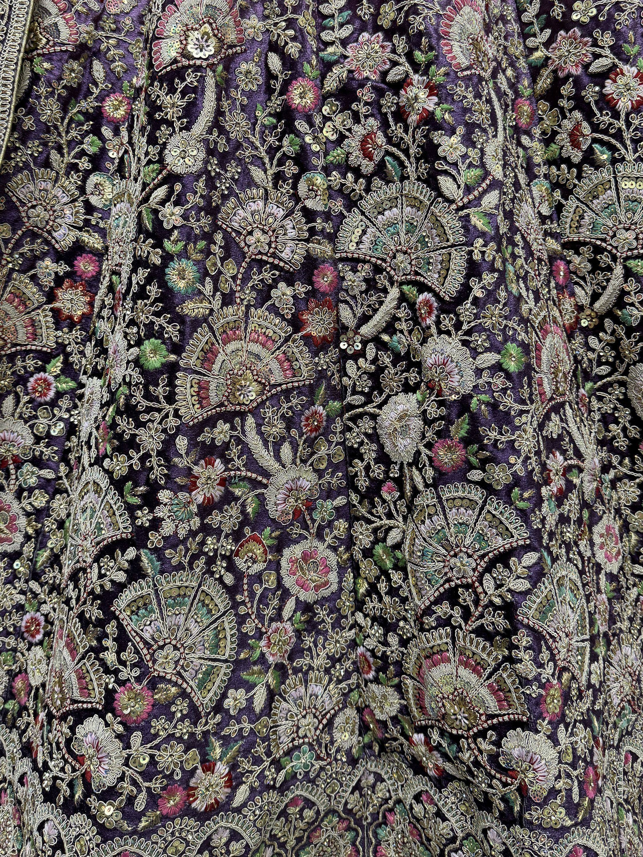 Purple velvet ethnic gown with intricate floral embroidery and sequins for festive occasions