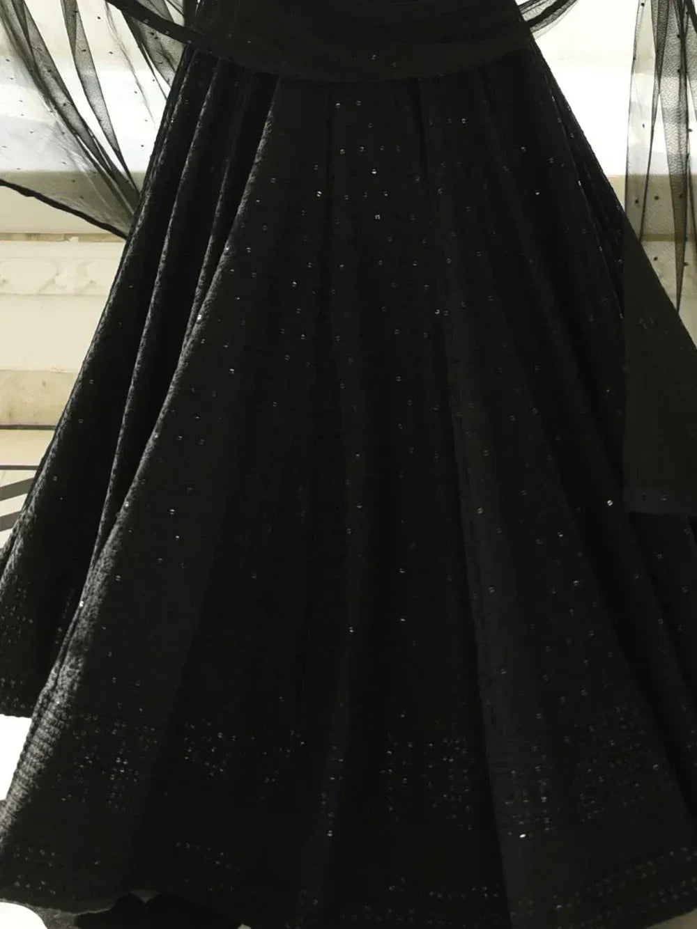 Black sequined ethnic gown with sheer overlay, perfect for festive occasions and weddings.
